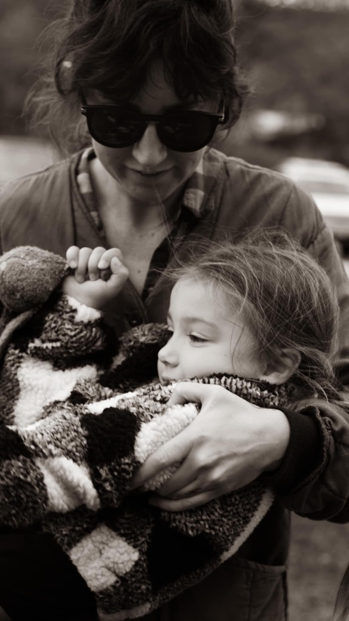Intimate black and white moment with cozy blanket embrace.