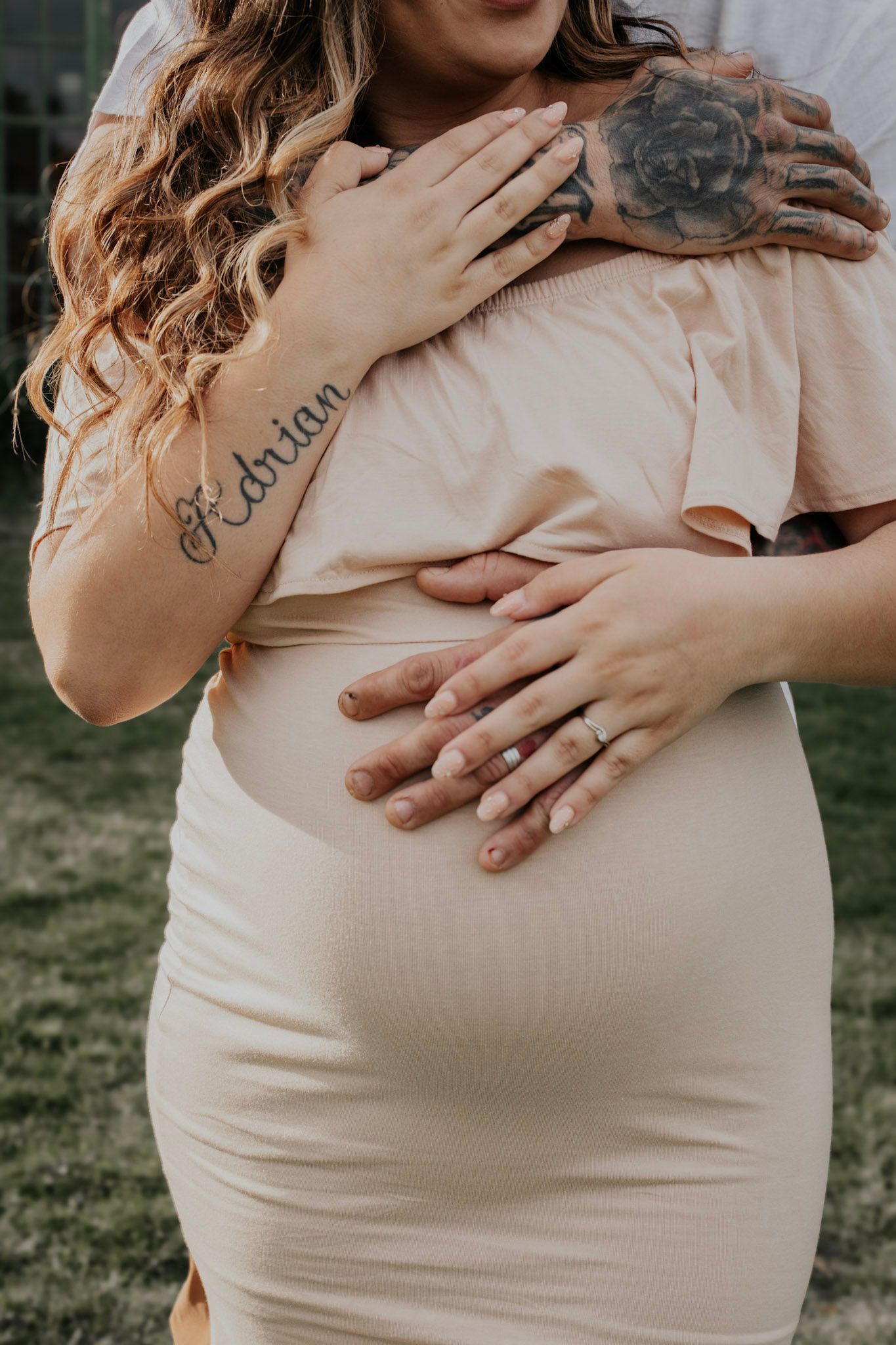 A series of maternity photos showing hands lovingly cradling a pregnant belly in a cream-colored dress against a natural backdrop.