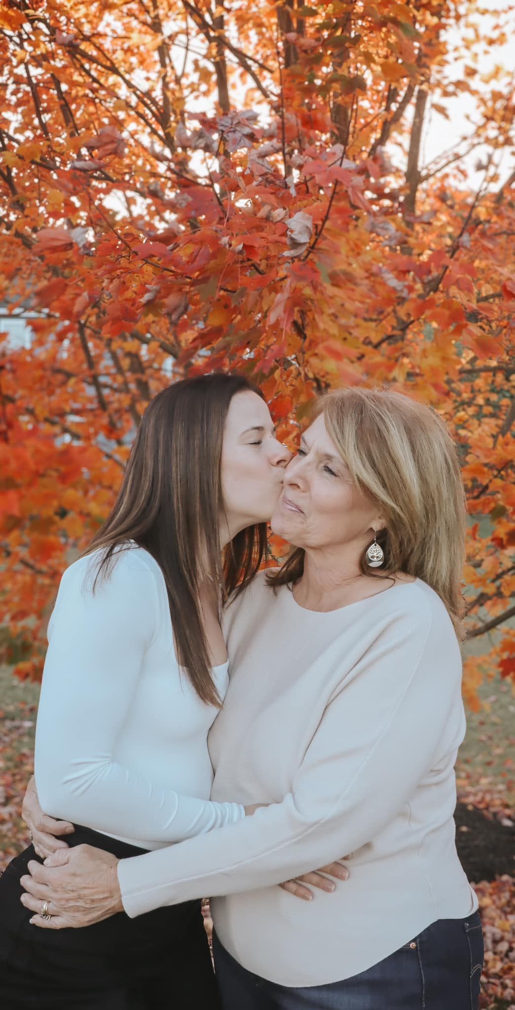 Intimate portrait series against vibrant orange autumn foliage.