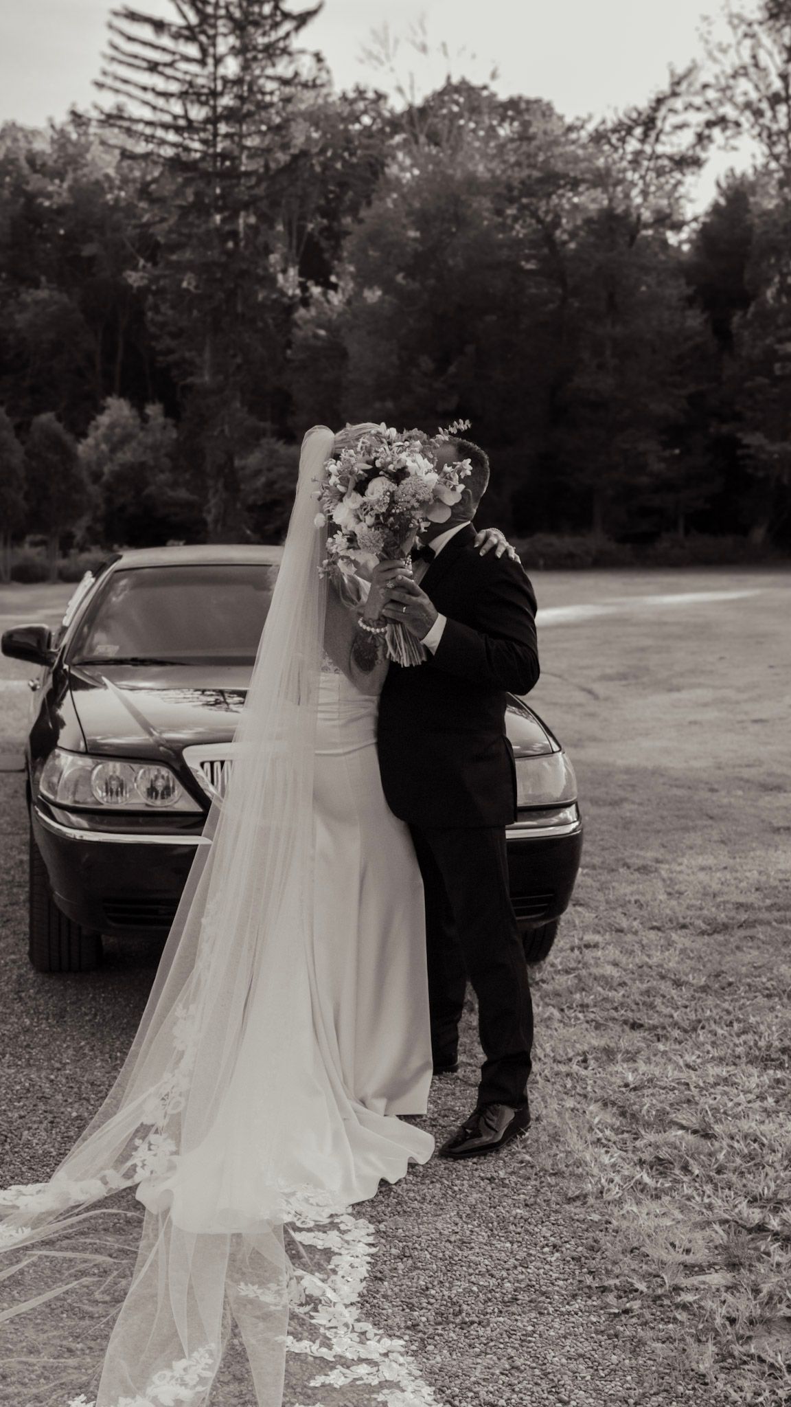 A sequence of black and white wedding photos showing a couple by their car in an outdoor setting.
