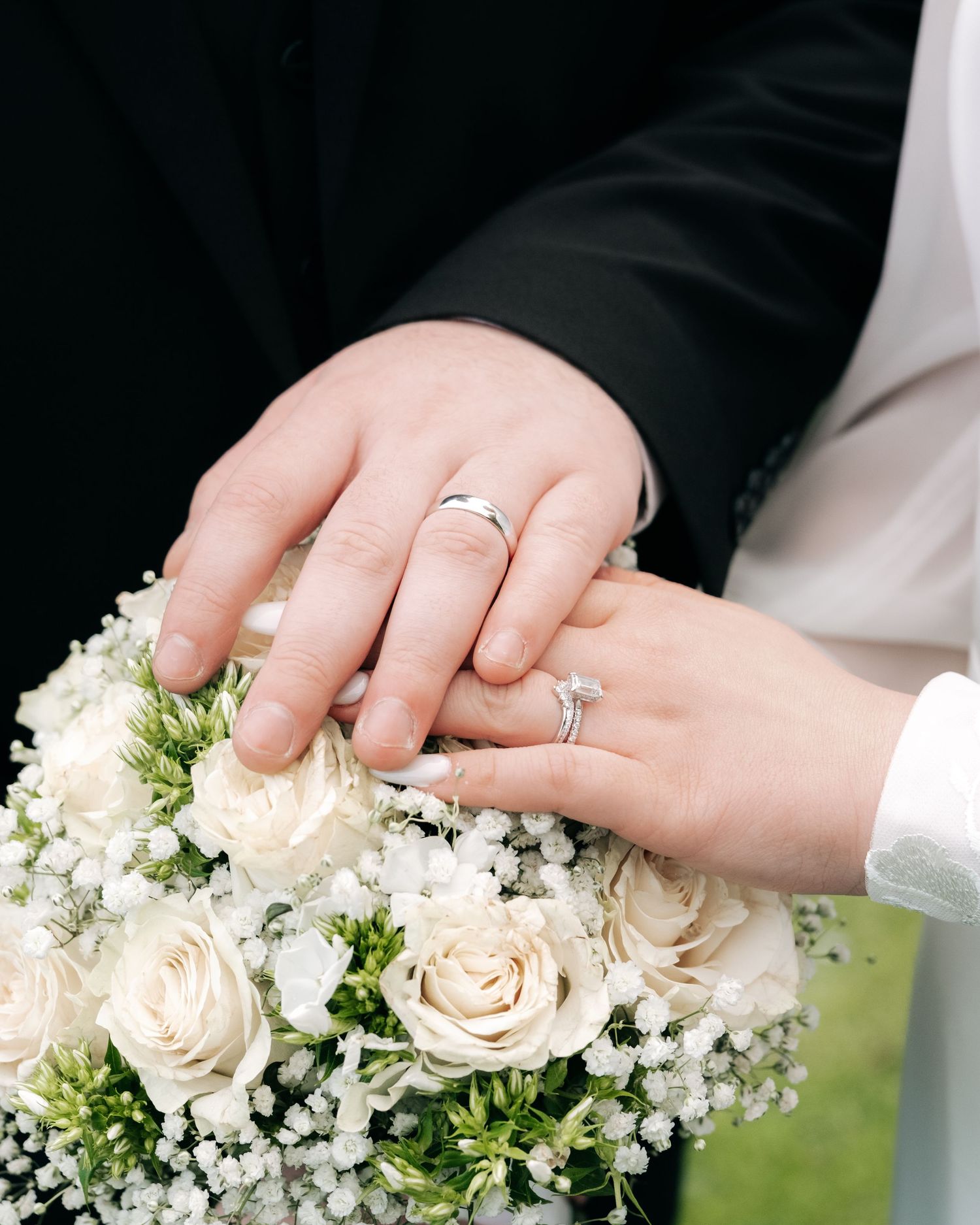 Close-up shots of wedding rings and white floral bouquet details.