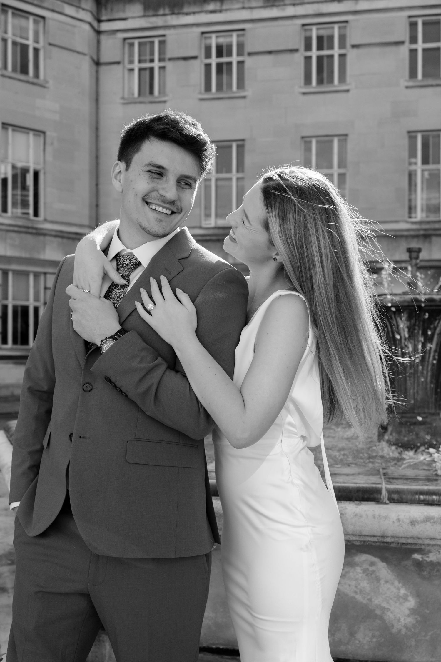 Black and white sequence of joyful wedding couple sharing laughs together.
