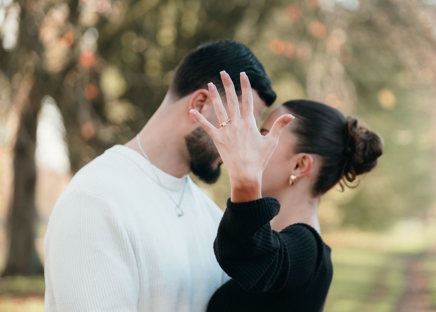 A romantic moment captured between two people in an outdoor setting.