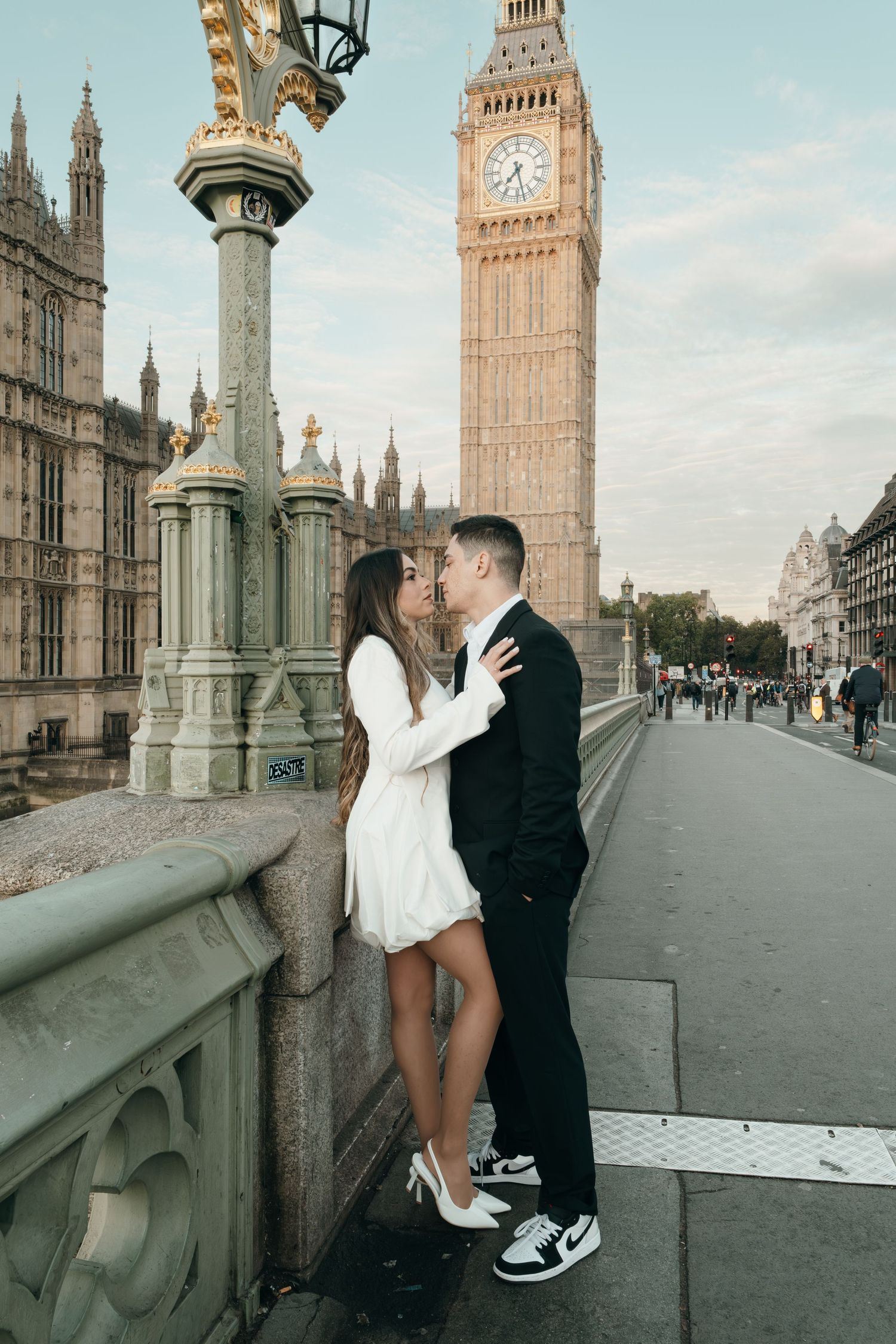 A romantic moment captured on Westminster Bridge with Big Ben in the background.