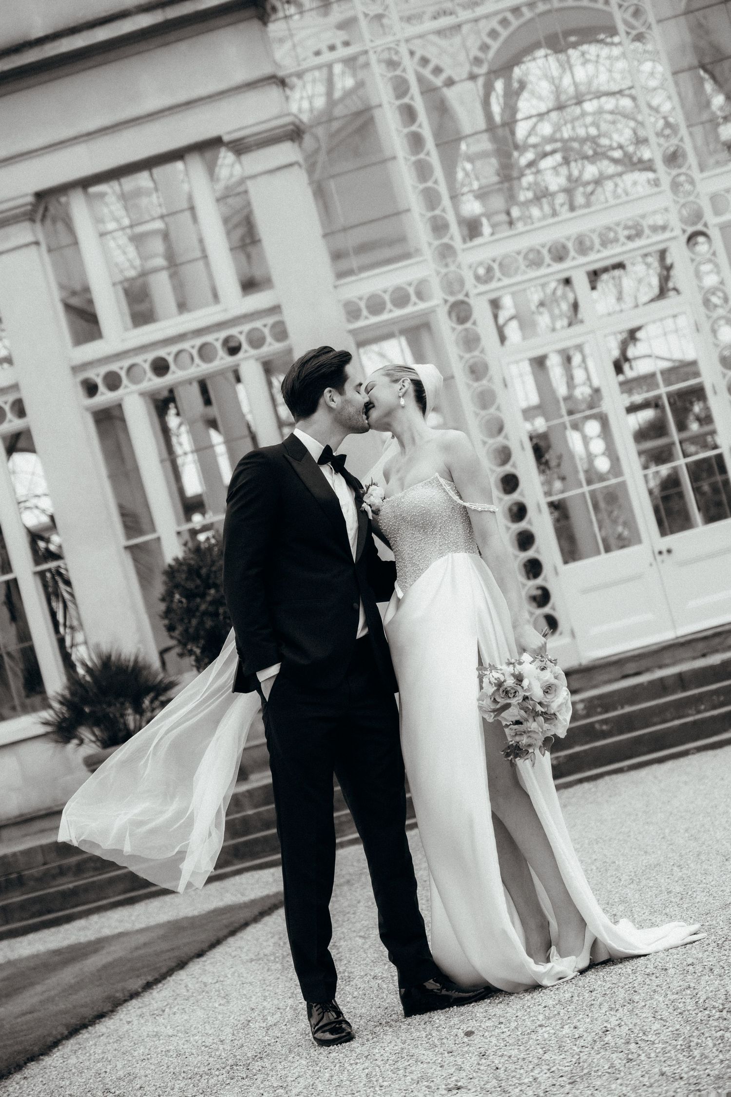 Wedding photo sequence in black and white showing moments outside a historic building.
