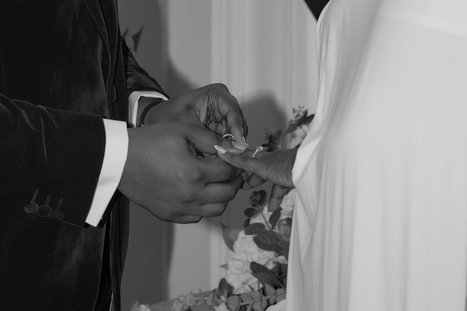 Close-up details of a couple's hands during an intimate moment.