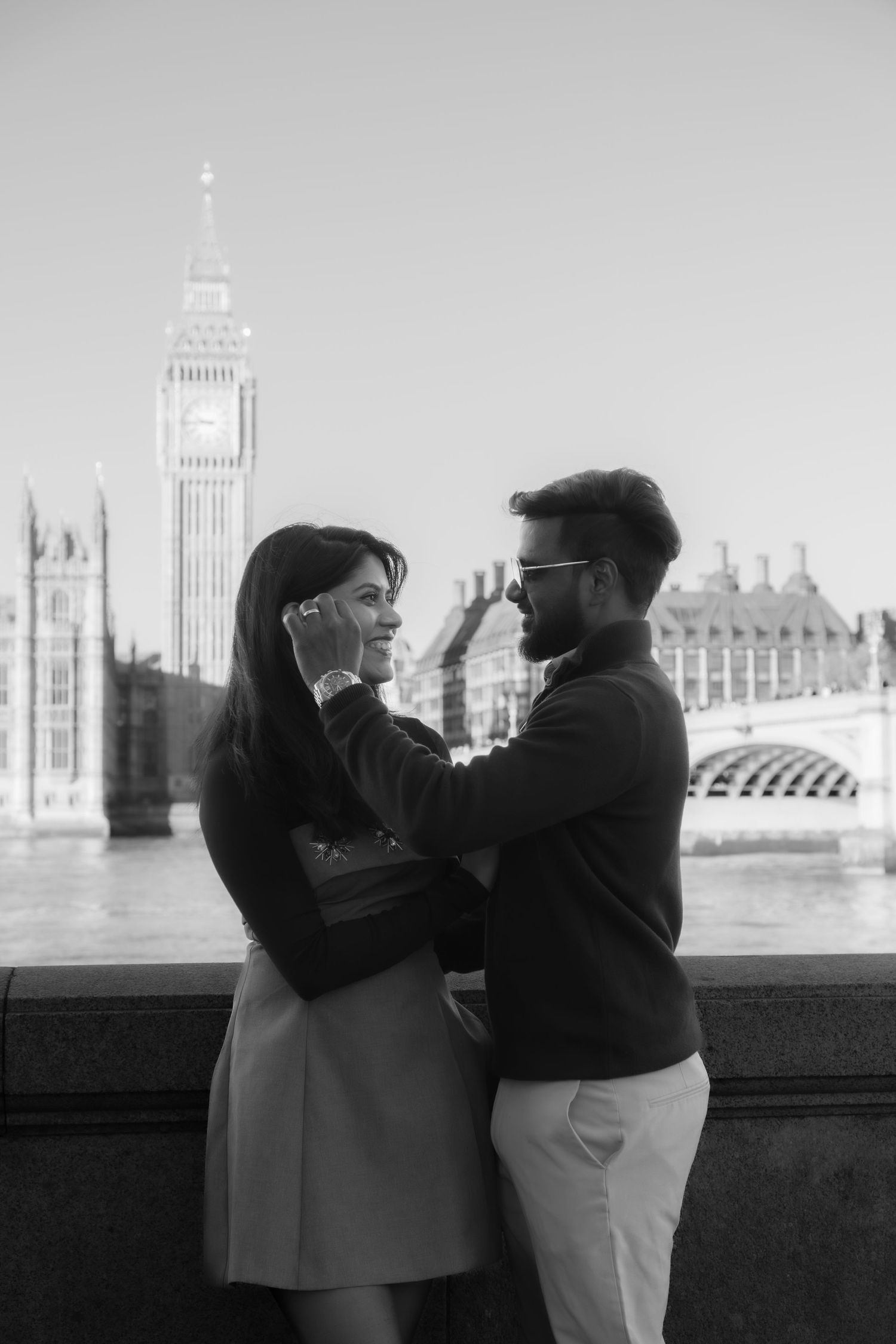 Romantic sequence overlooking the Thames with London's iconic Parliament building in the background.