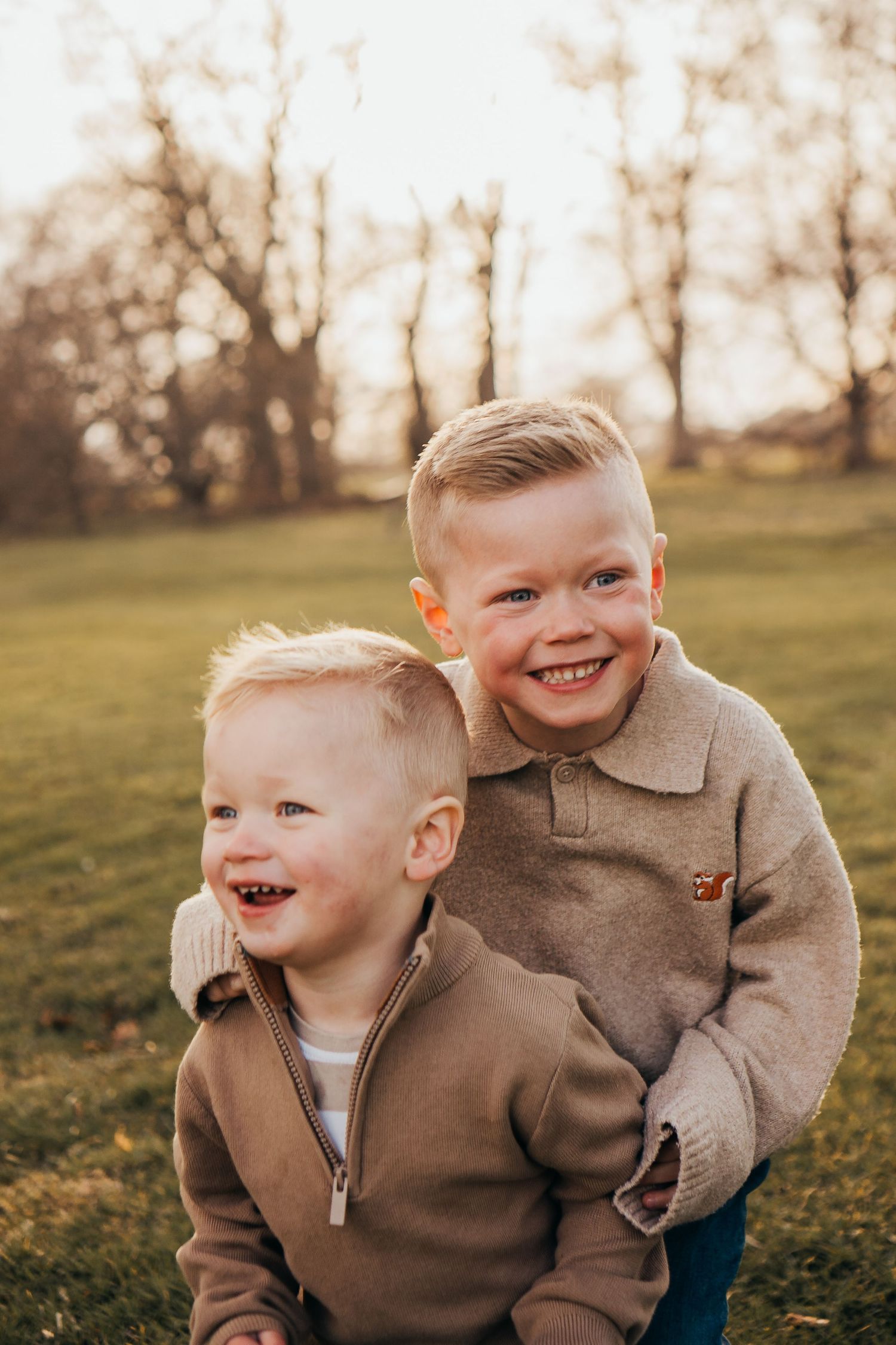 Two smiling brothers having fun during a golden hour family session