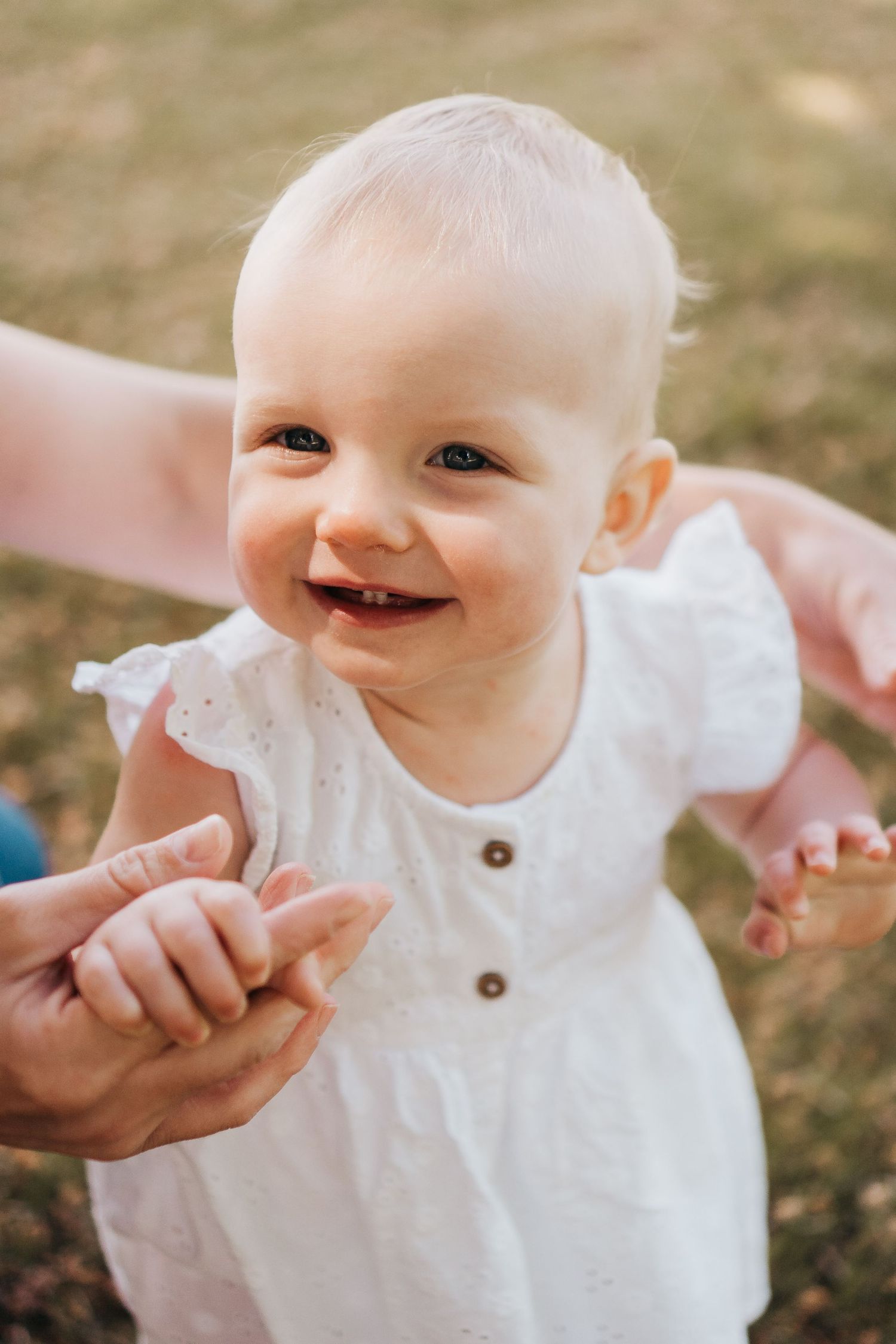 baby girl taking steps during her first birthday milestone session