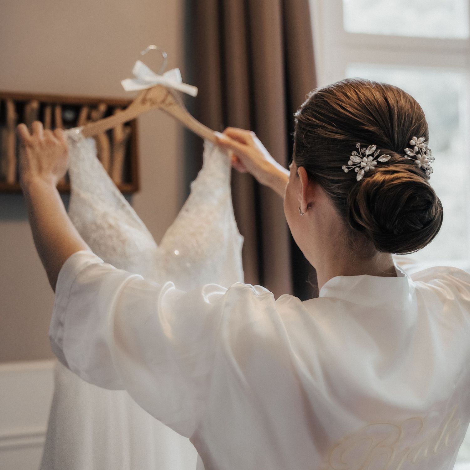Bruid bewondert haar trouwjurk – bruidsfotografie, bridal details, trouwdag, Nederland
