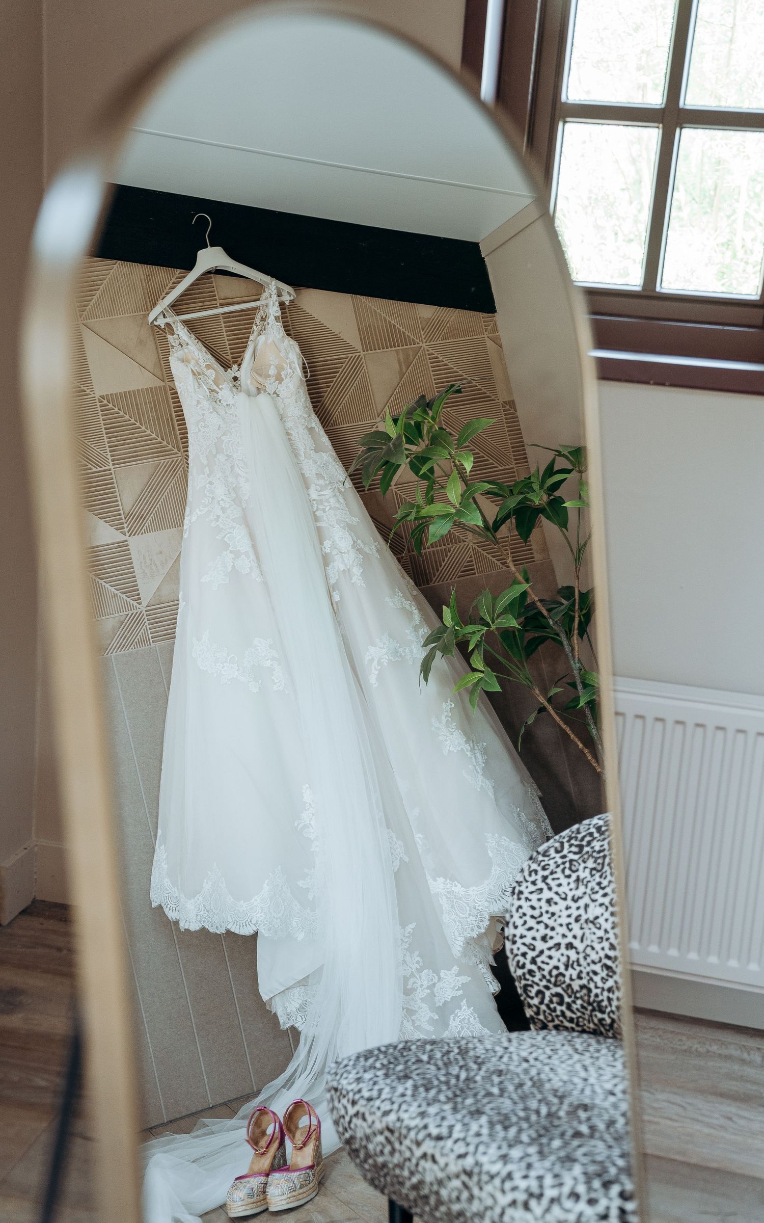 Witte trouwjurken hangend in een lichte kamer – bruidsfotografie, bridal details, trouwdag, Nederland