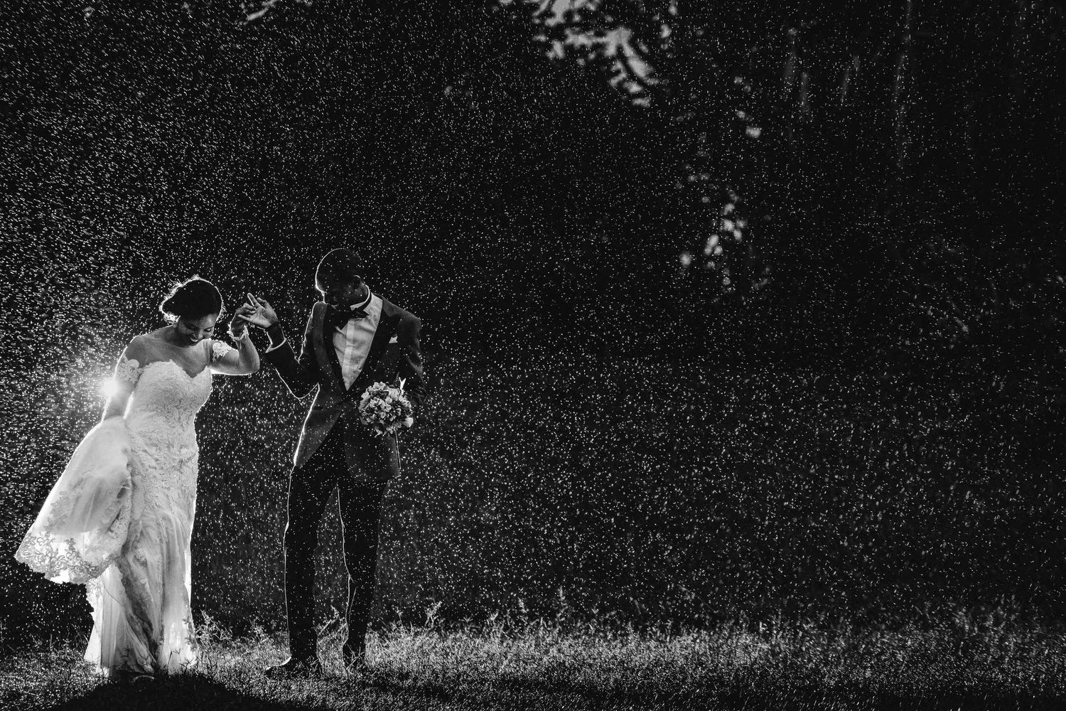 Black and white wedding photography sequence showing movement across a meadow.