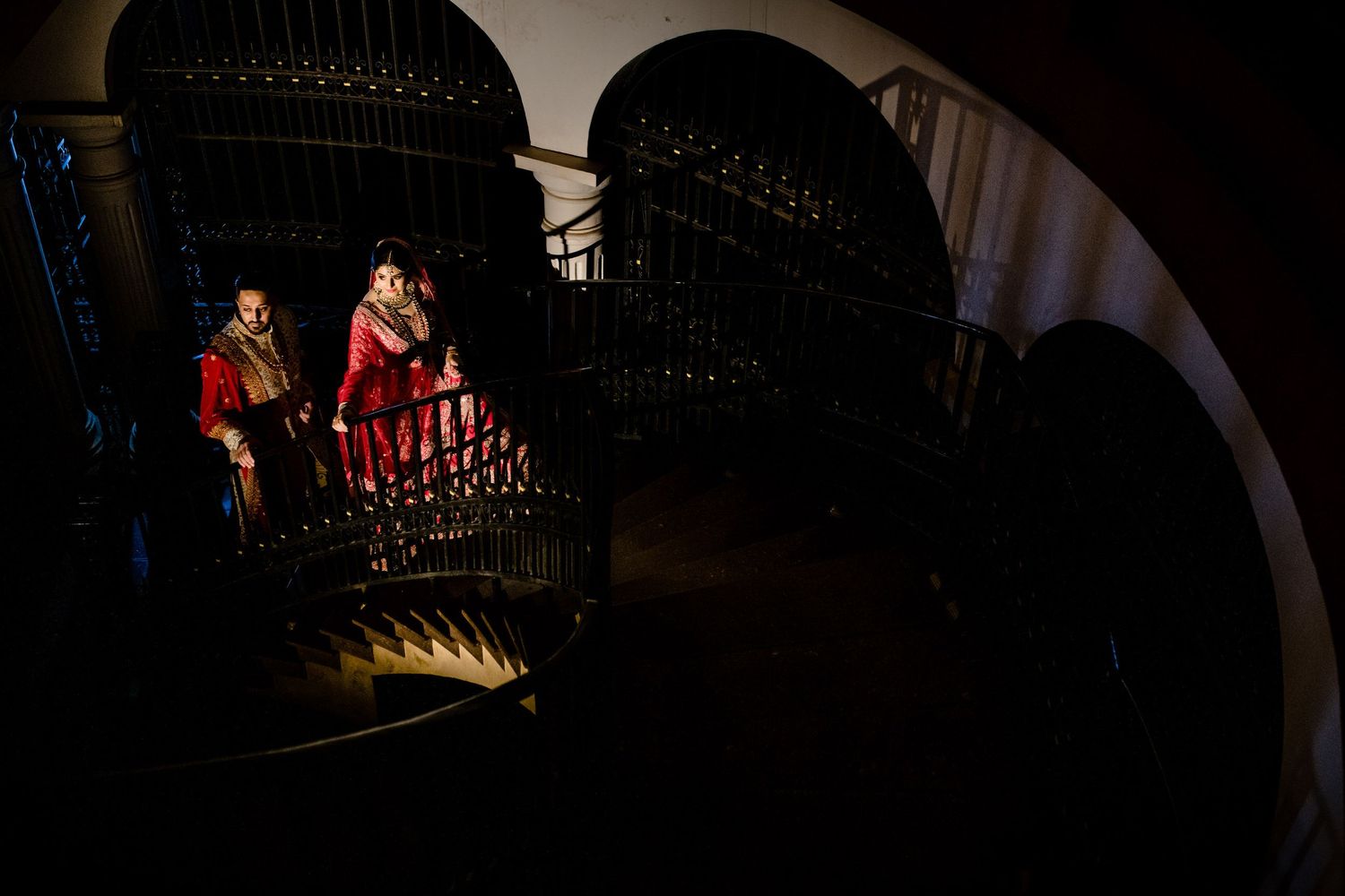 Dramatic nighttime lighting through archways creating shadow patterns.