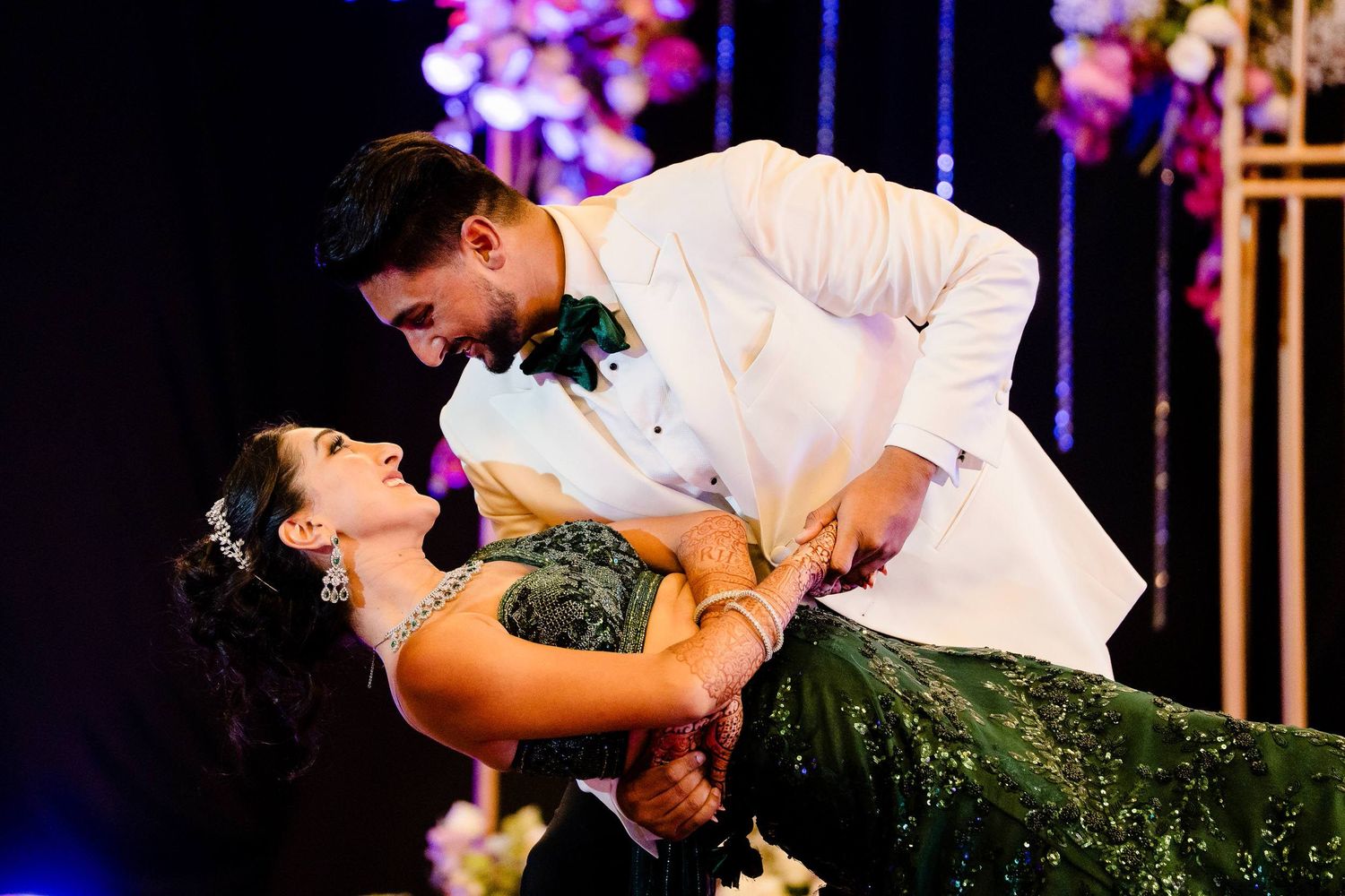 Romantic dance performance at an elegant wedding reception with dramatic lighting and decorative elements.