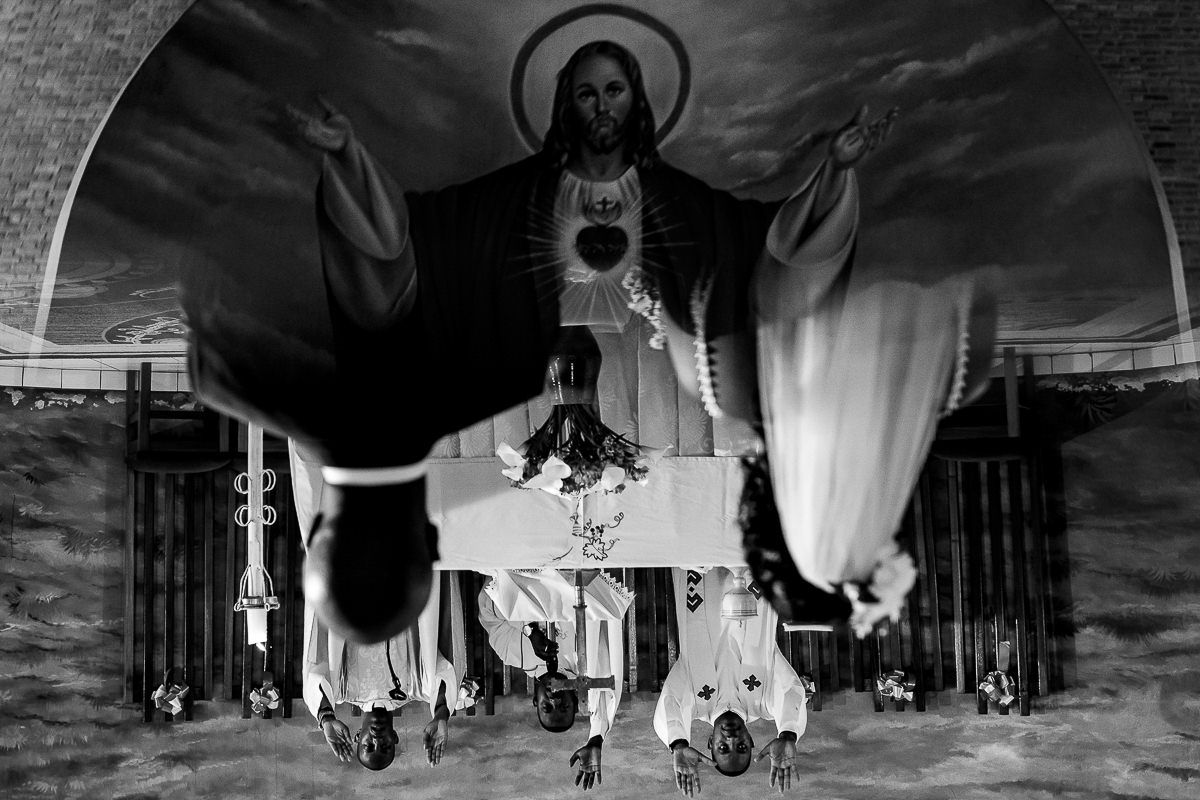 Dramatic black and white wedding venue shots with flowing white fabric decorations.