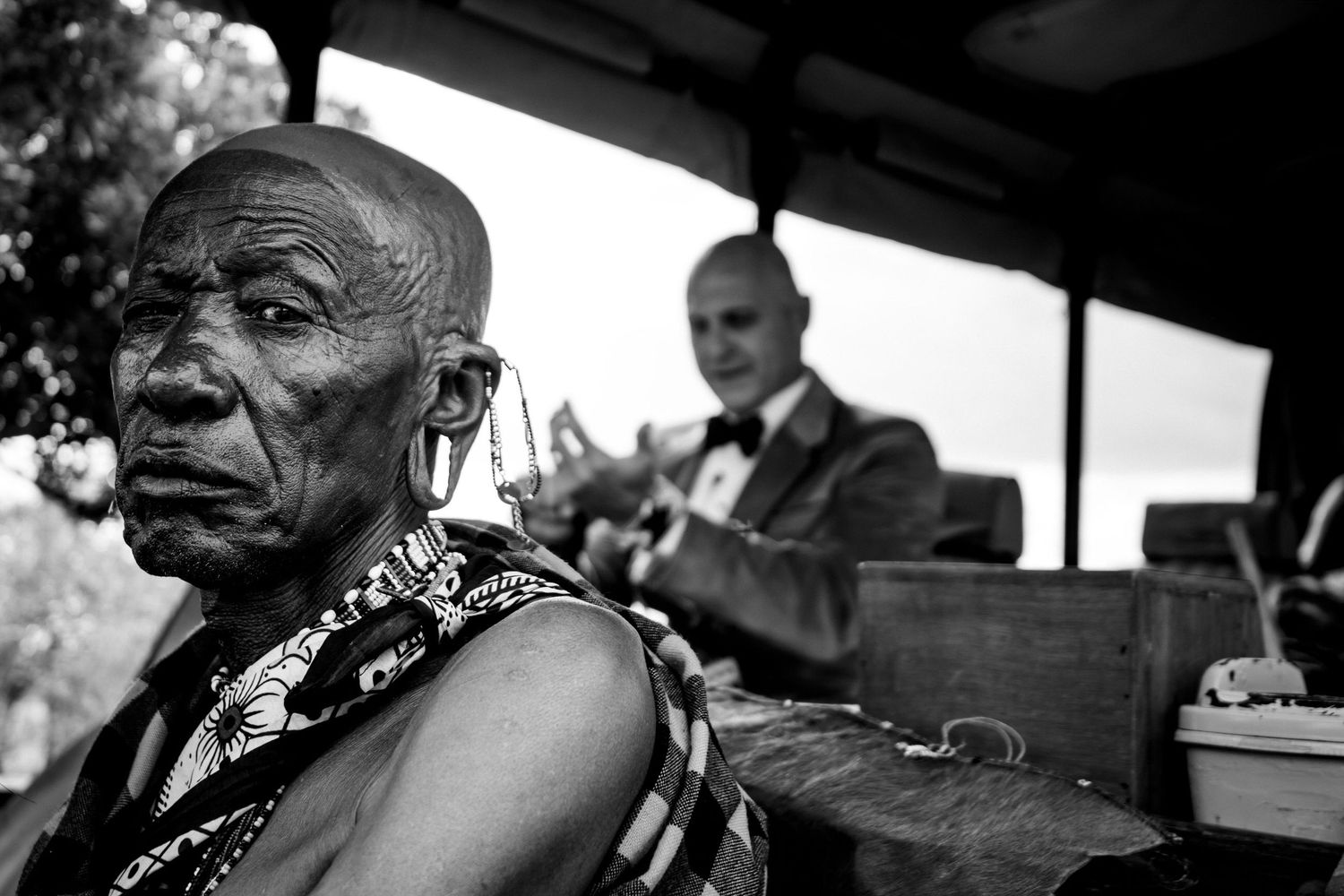 Black and white portrait showing traditional African attire and cultural expression.