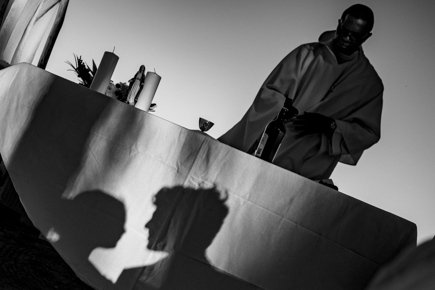 High contrast black and white silhouettes of wedding guests and decorations.