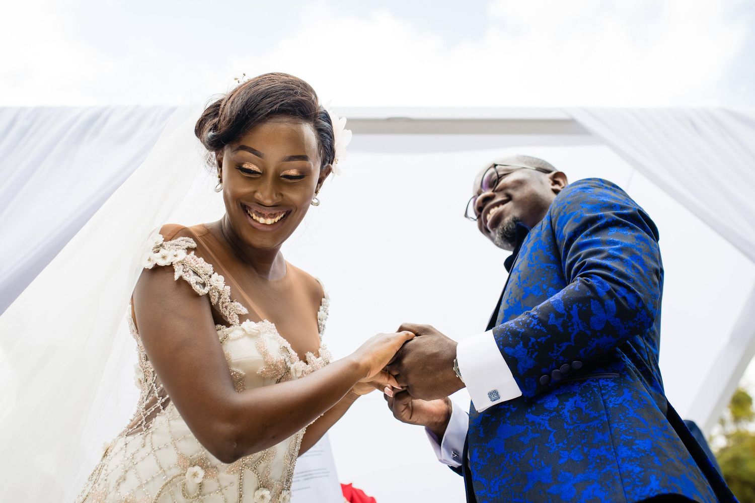 Joyful wedding couple sharing an intimate moment during their outdoor celebration.