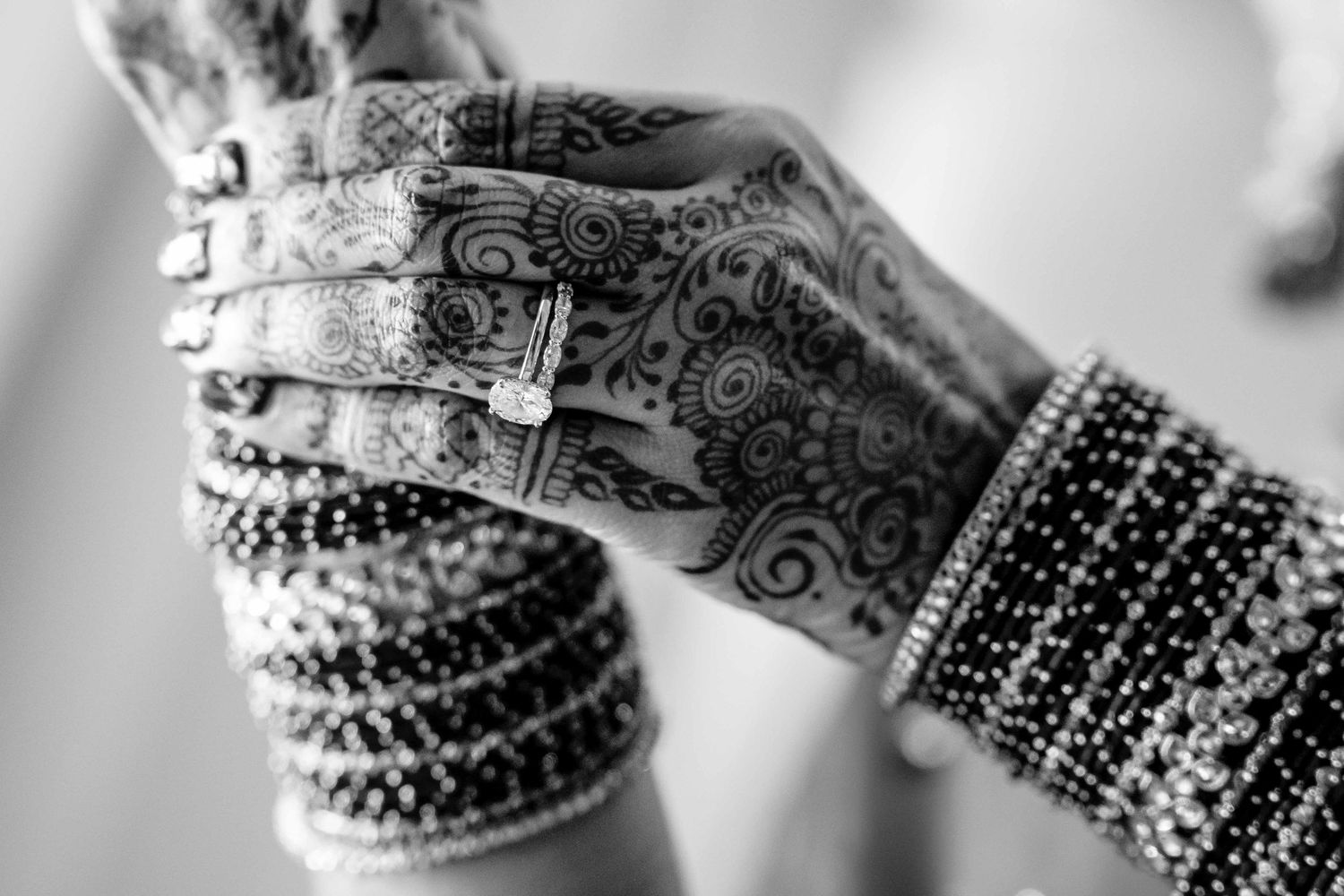 Intricate henna designs and patterns adorn hands in traditional Indian mehndi art style.