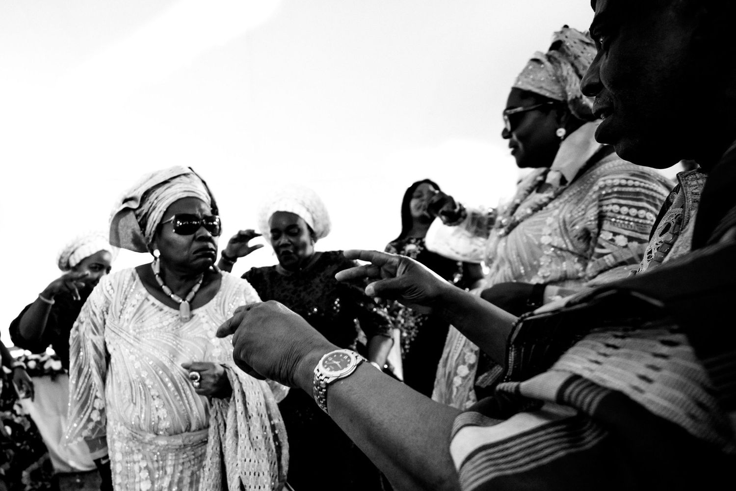 Black and white candid shots of people interacting at an event.