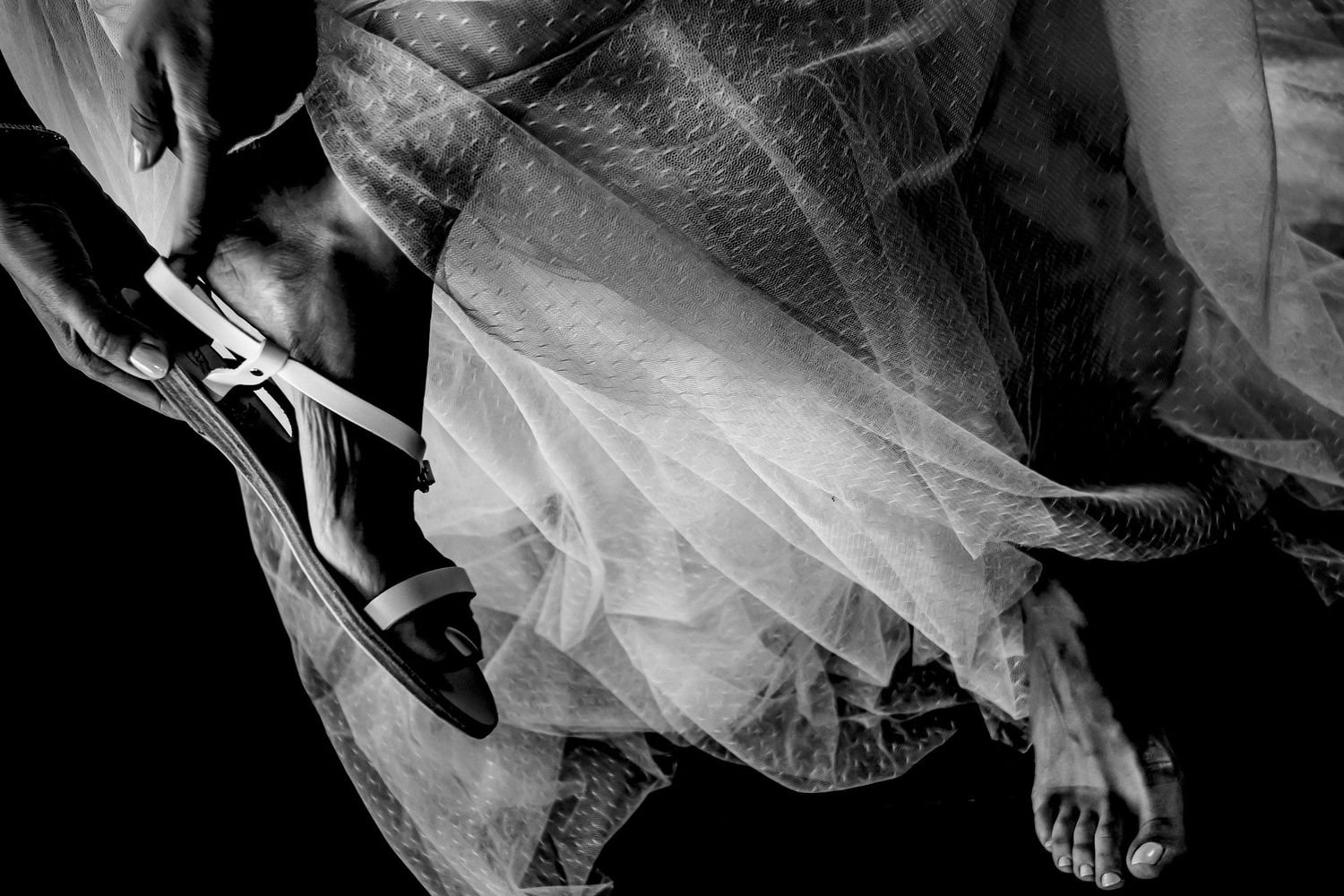Artistic black and white photo of a bride getting ready on her wedding day.