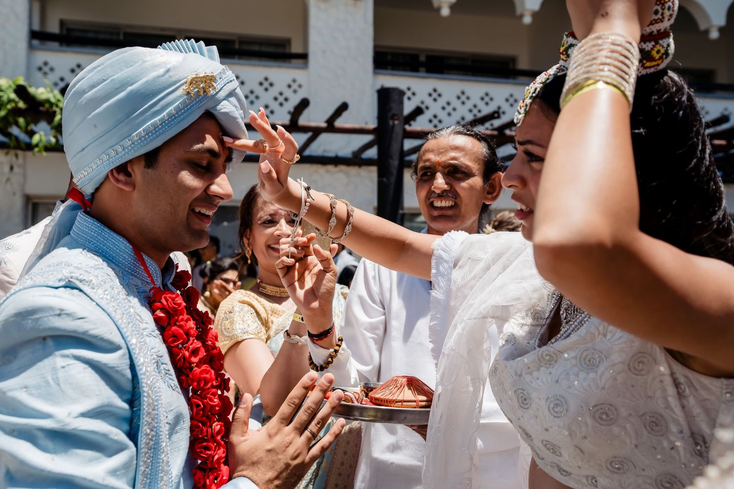 Festive dancing and celebrations at an Indian wedding with traditional attire and decorations.