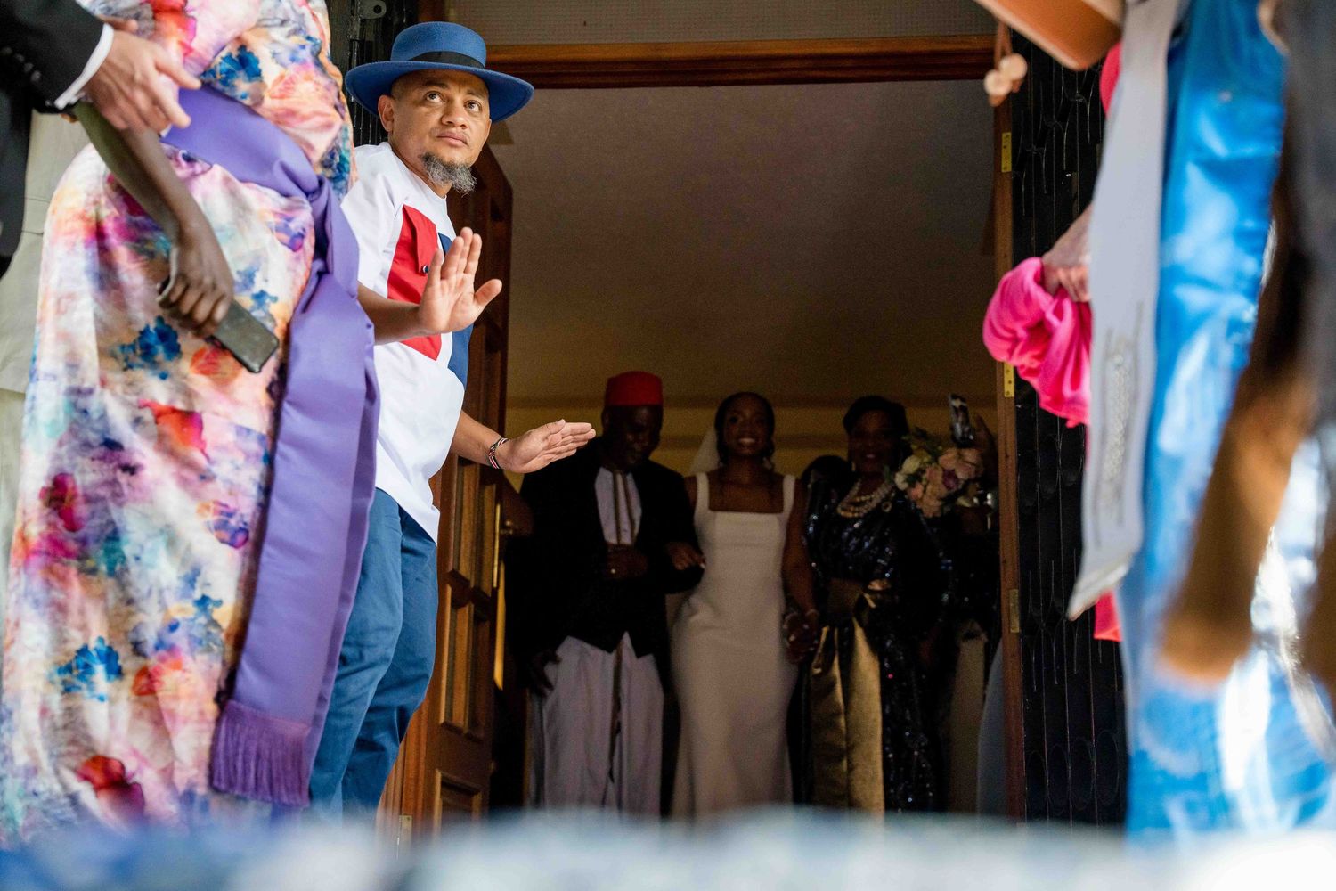 People dancing together at a social gathering with colorful clothing and blurred motion.