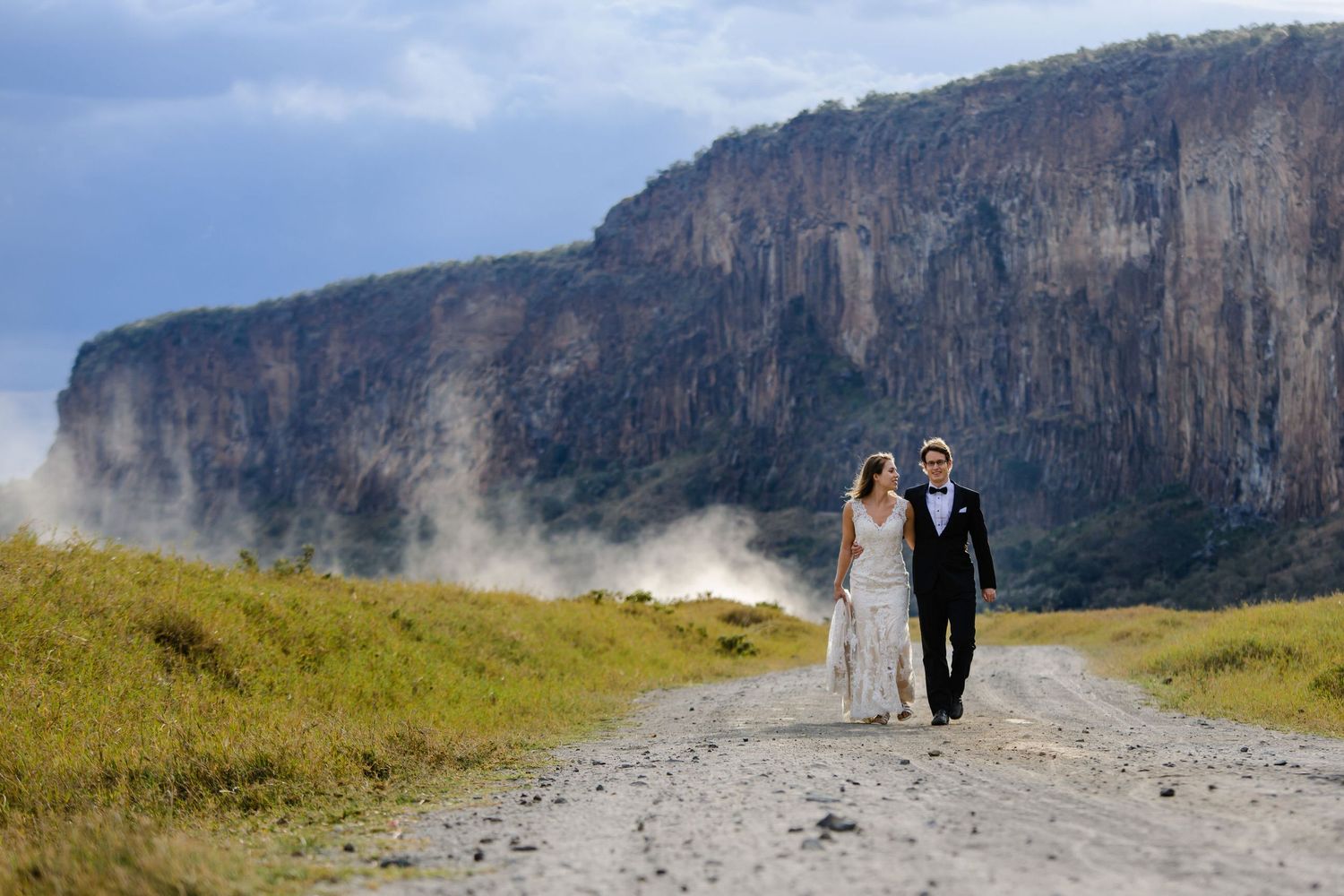 Scenic mountain cliffs with misty atmosphere and walking path.