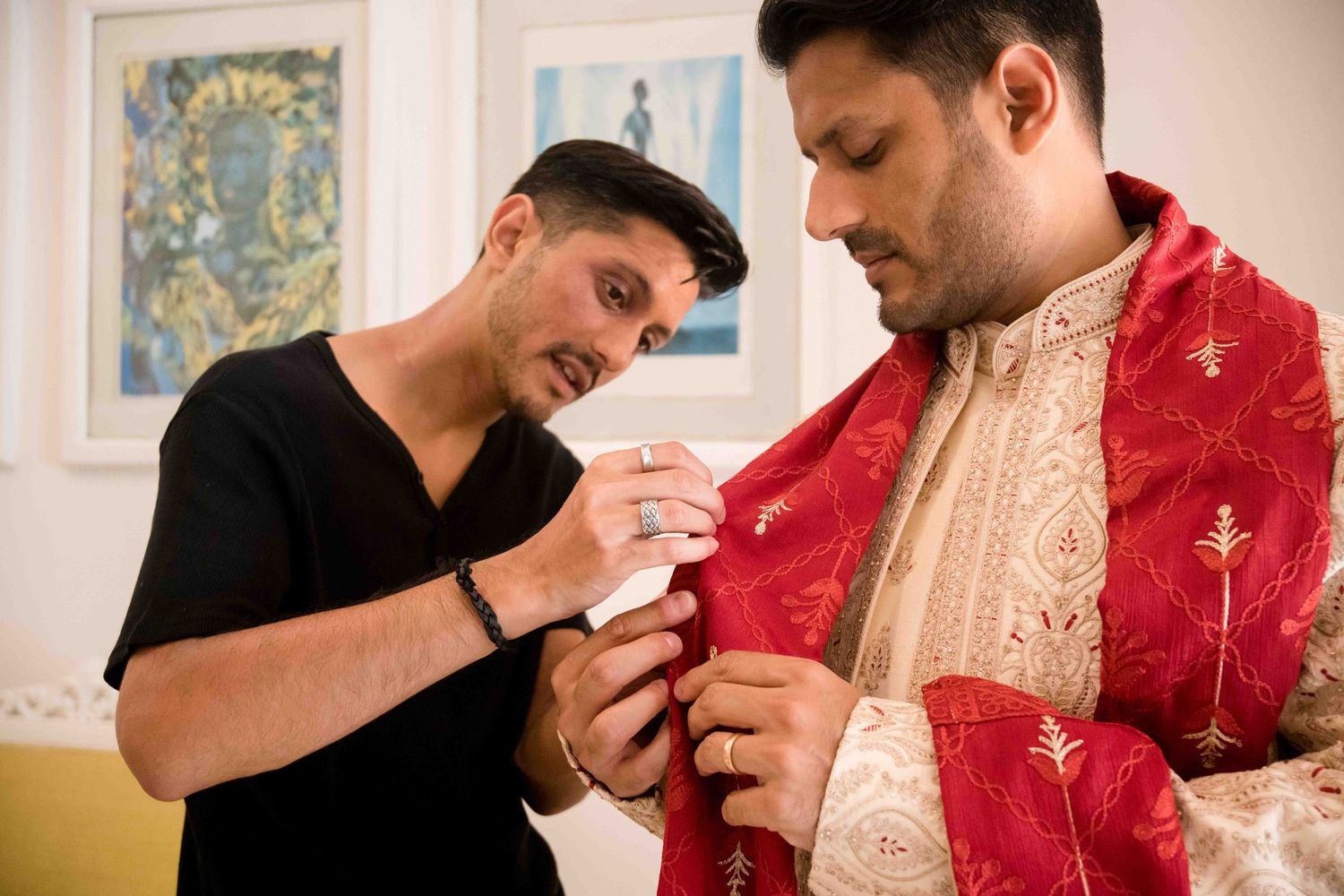 A couple in traditional South Asian wedding attire shares an intimate moment during their ceremony.