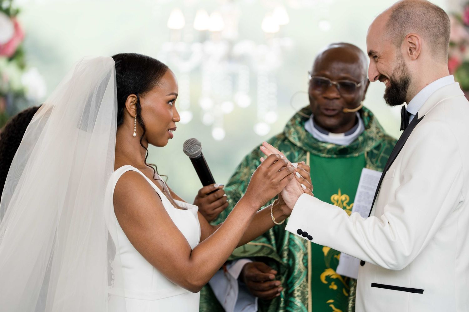 A wedding ceremony with the couple and officiant exchanging vows at the altar during a traditional church service.