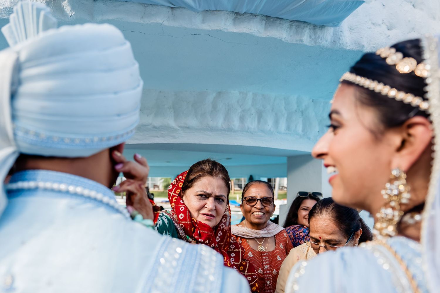 Traditional wedding ceremony guests in cultural attire during celebration.