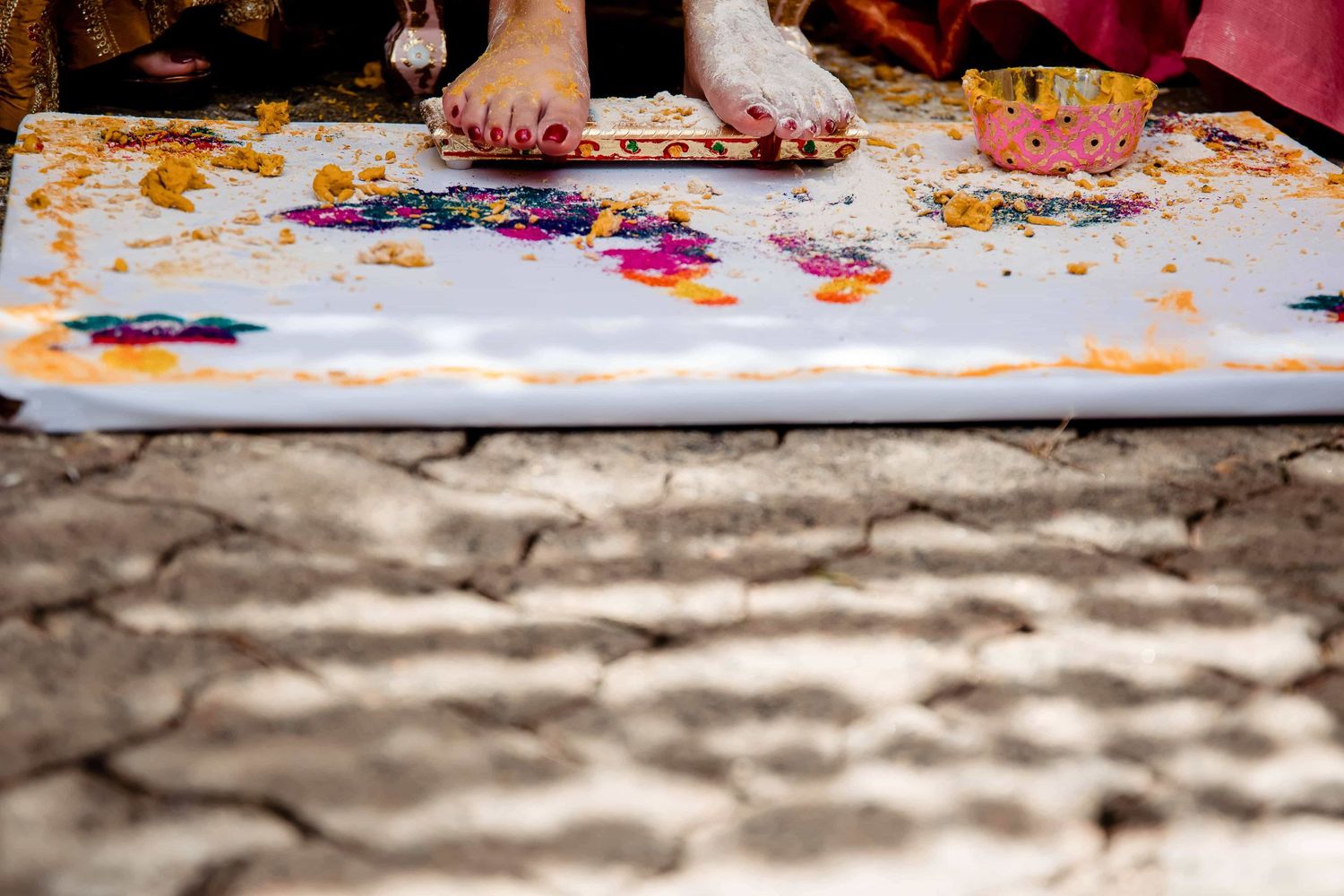 Close up of feet and colorful paint splatters during a creative art session.