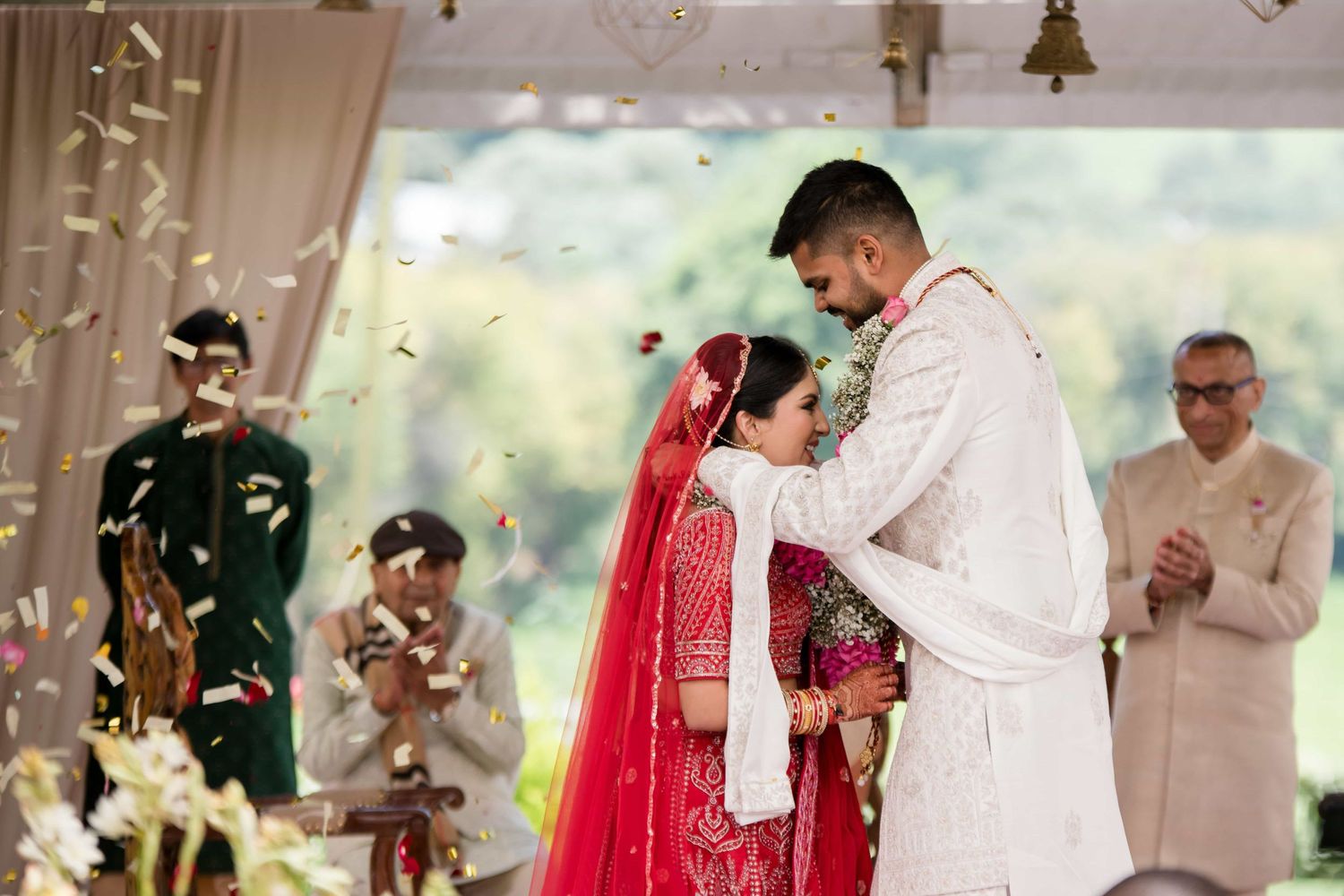 Traditional wedding ceremony moment with confetti falling during an emotional exchange.