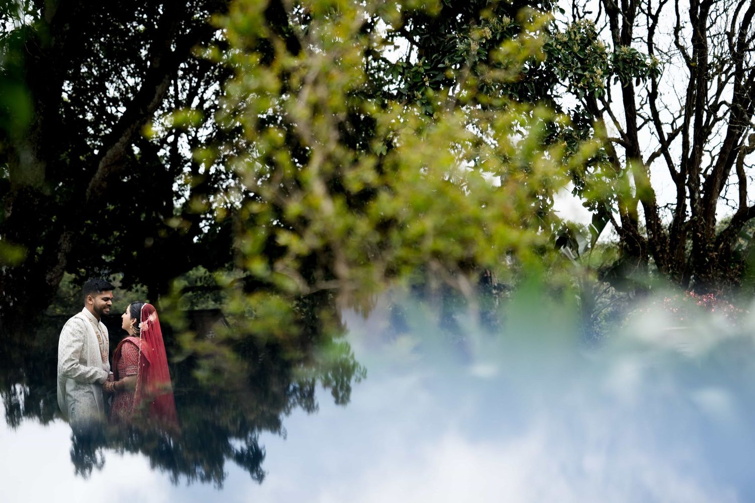 Artistic wedding photo with foggy foreground creating a dreamy atmosphere in nature.