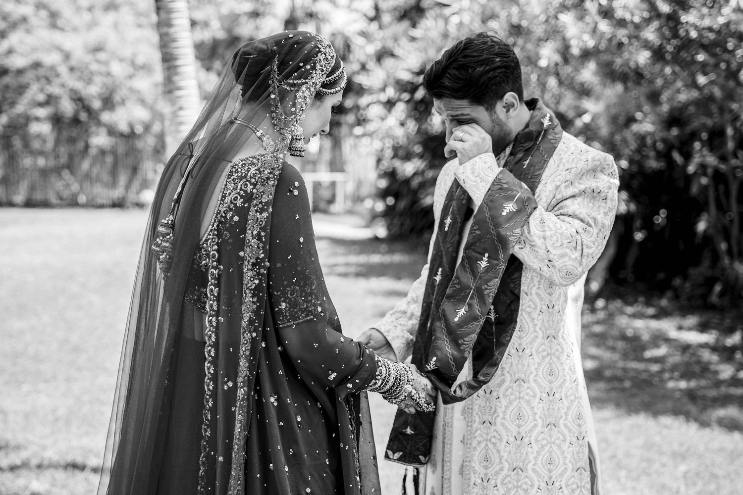 Black and white photo sequence showing an outdoor wedding ceremony with people gathered in a garden setting.