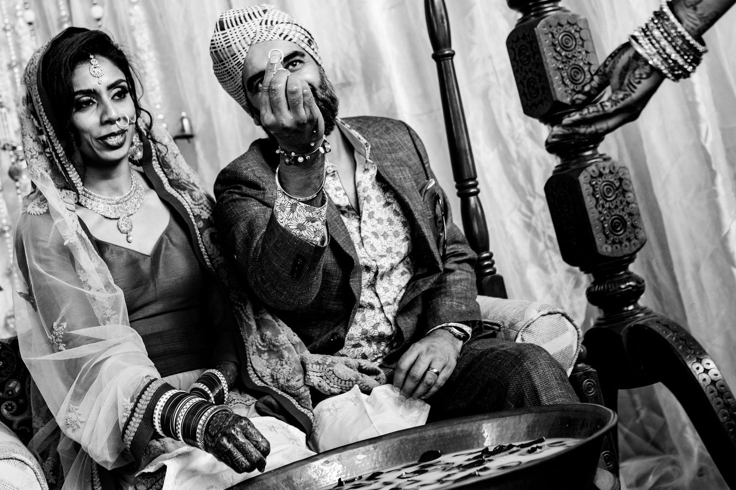 Wedding guests celebrate during an indoor reception with traditional Indian decor and festivities.