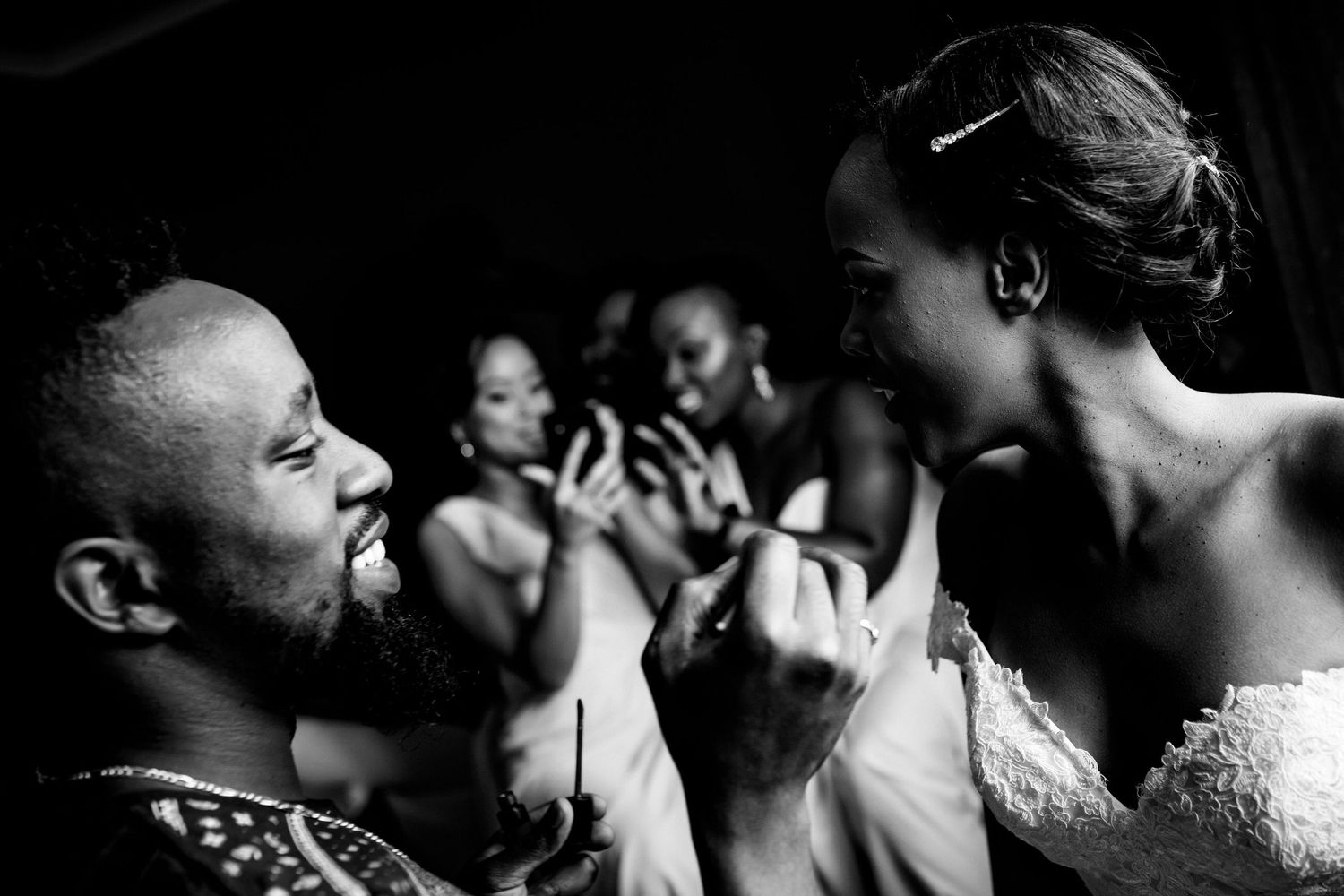 Candid black and white photo capturing joyful moments during a wedding celebration.