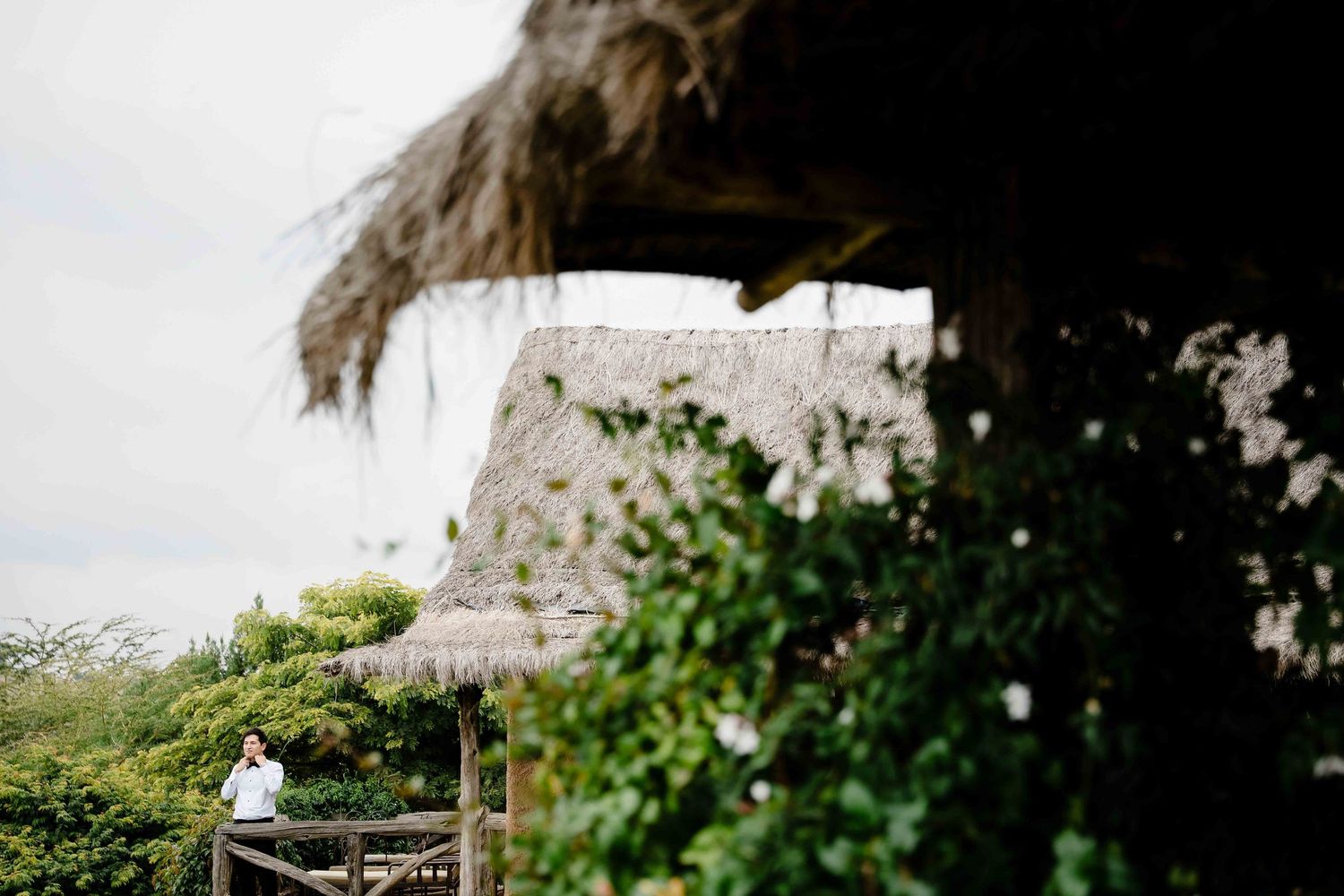 A collection of tropical beach wedding ceremony photos showing decorations and floral arrangements under palm trees.