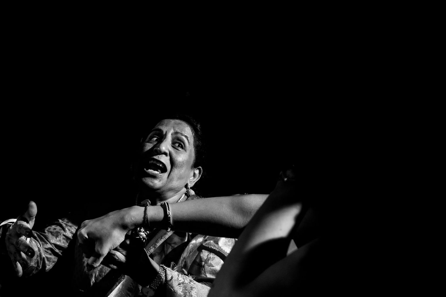 Black and white photos capturing joyful dancing moments at a celebration.