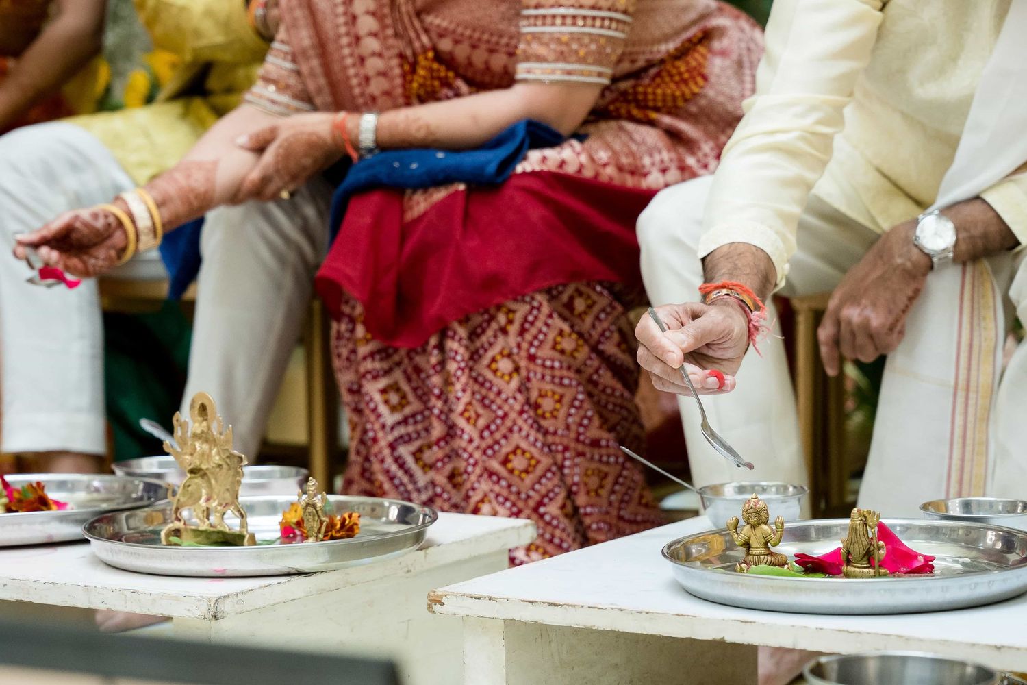 Traditional Indian dining setup with colorful textiles and plates of food.