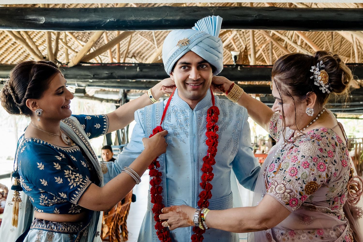 Traditional Indian wedding preparation with guests in colorful cultural attire.