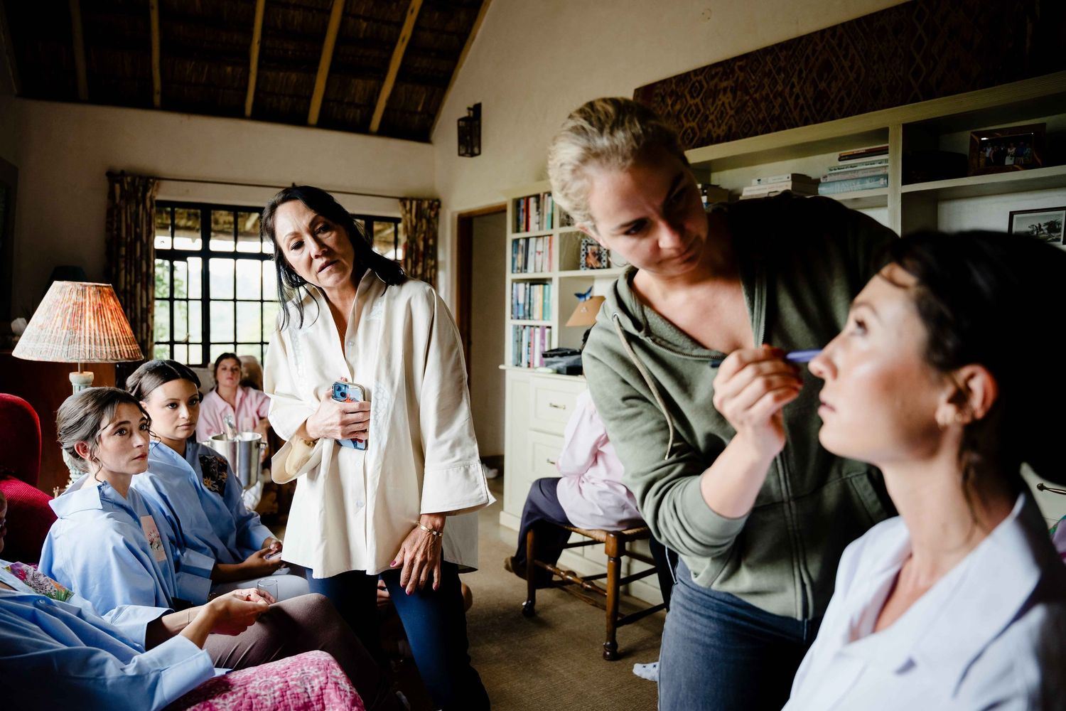 A group of wedding guests share laughter and joyful moments during a candid reception celebration.