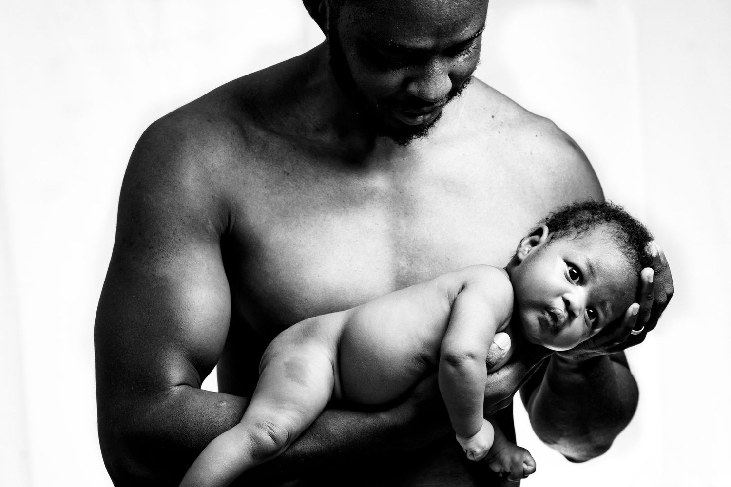 Black and white artistic portraits showing tender moments with a newborn.