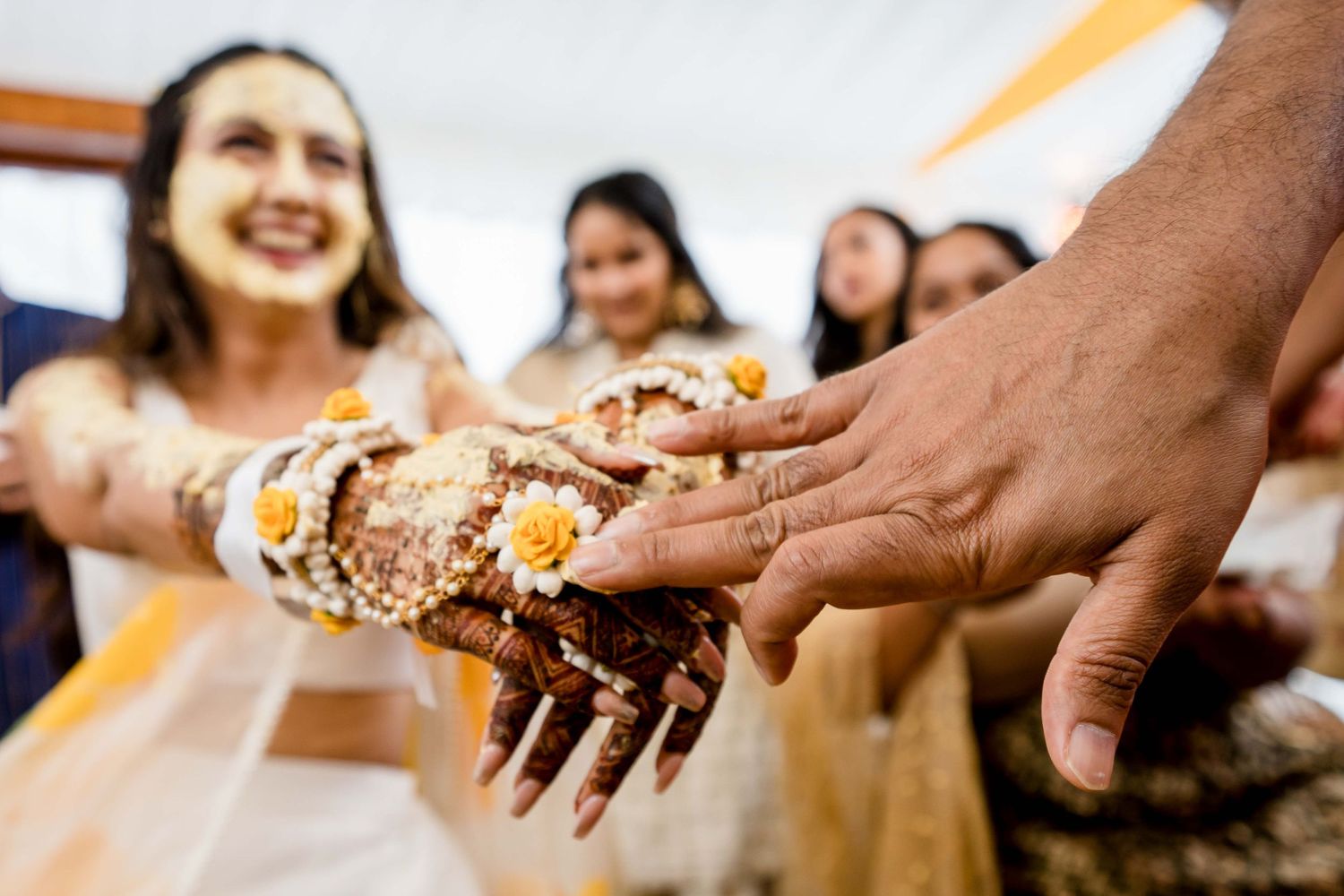 Close-up of hands decorated with henna during a traditional celebration ceremony.