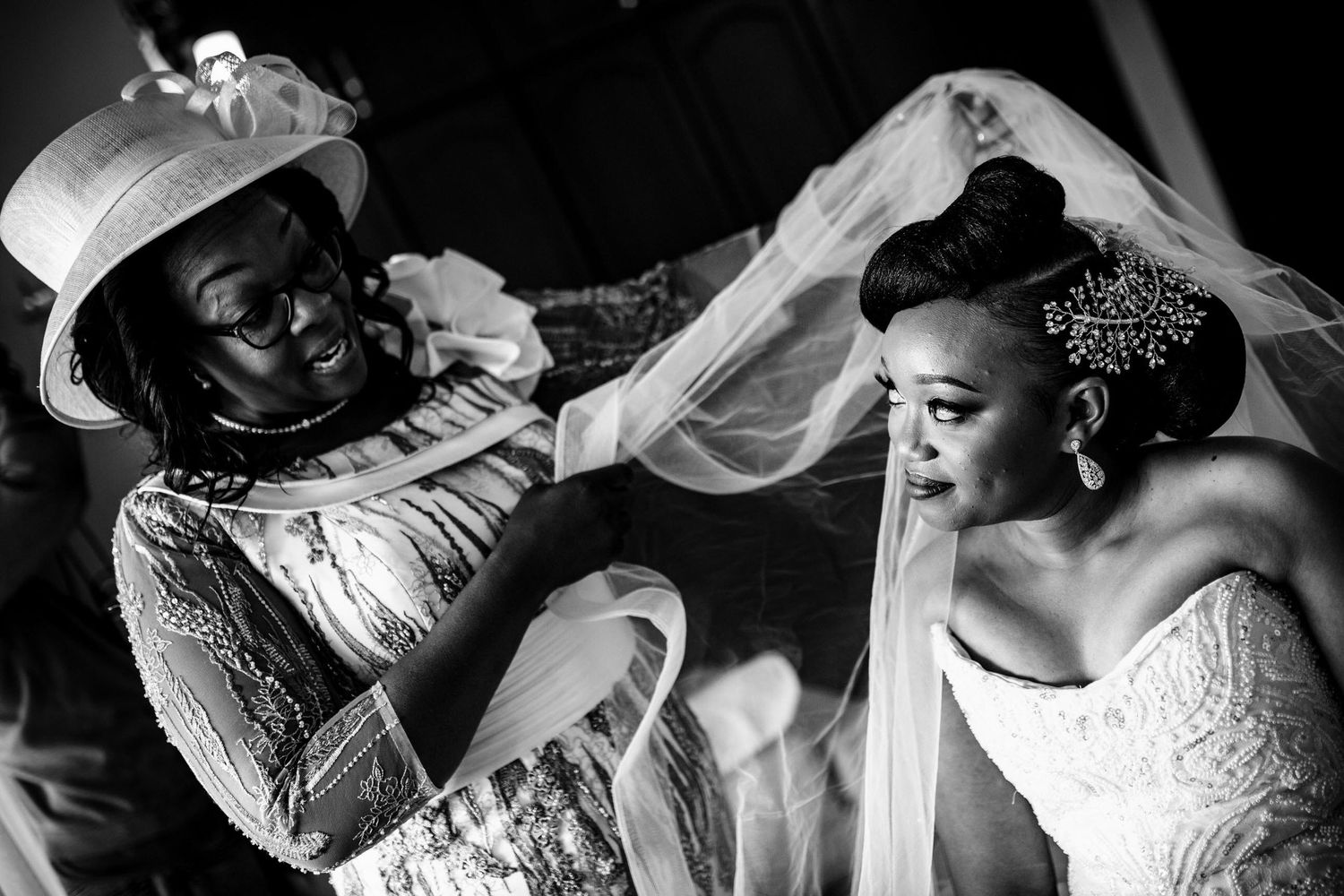 Series of candid moments showing wedding dress preparations in black and white.