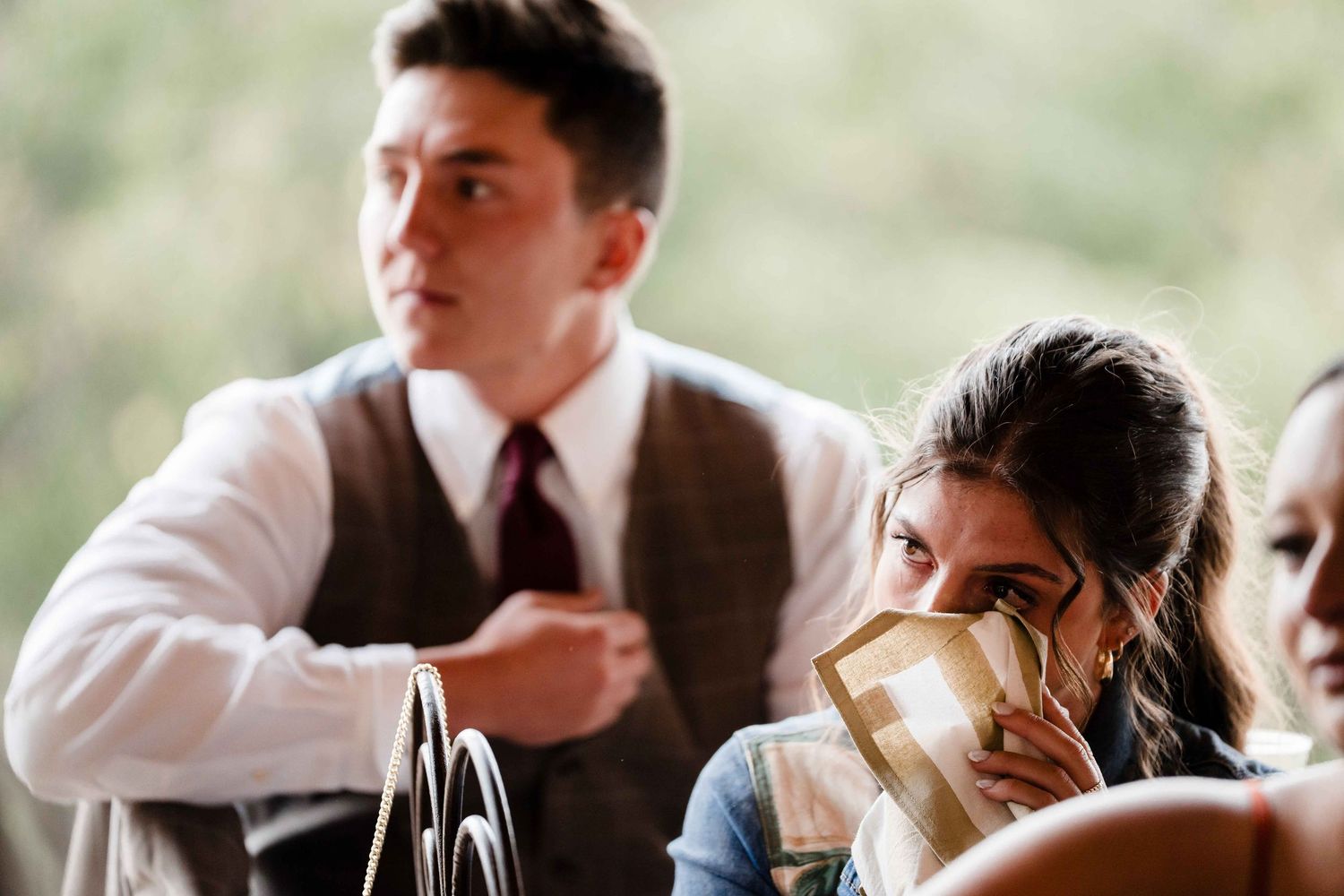 People enjoying wine and conversation at an elegant dinner party in formal attire.