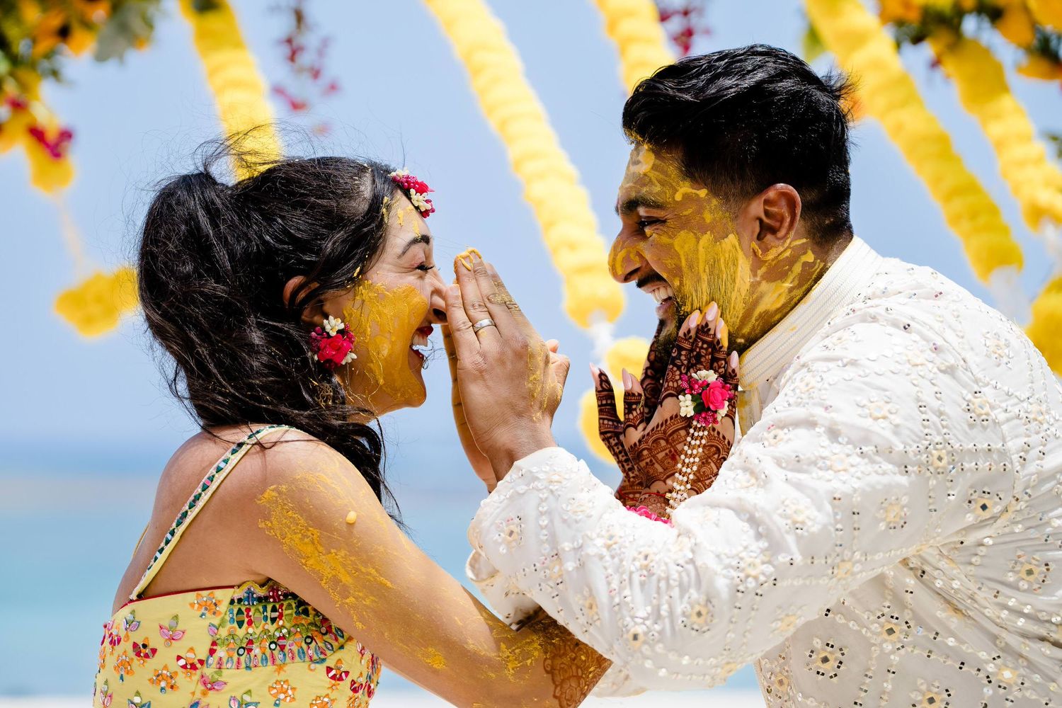 A sequence of joyful moments from a traditional Indian wedding celebration with vibrant yellow decorations.