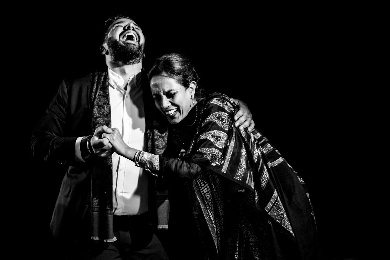 Dramatic black and white shots of dance partners in emotional poses.