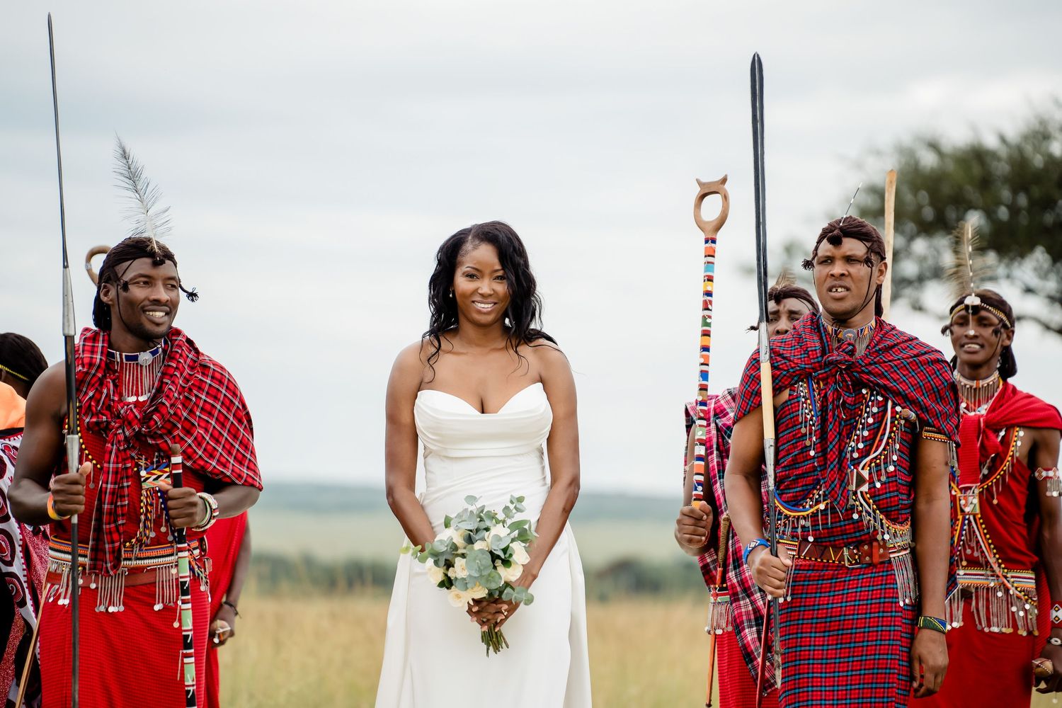 Wedding ceremony with traditional Maasai warriors in ceremonial red dress and jewelry.