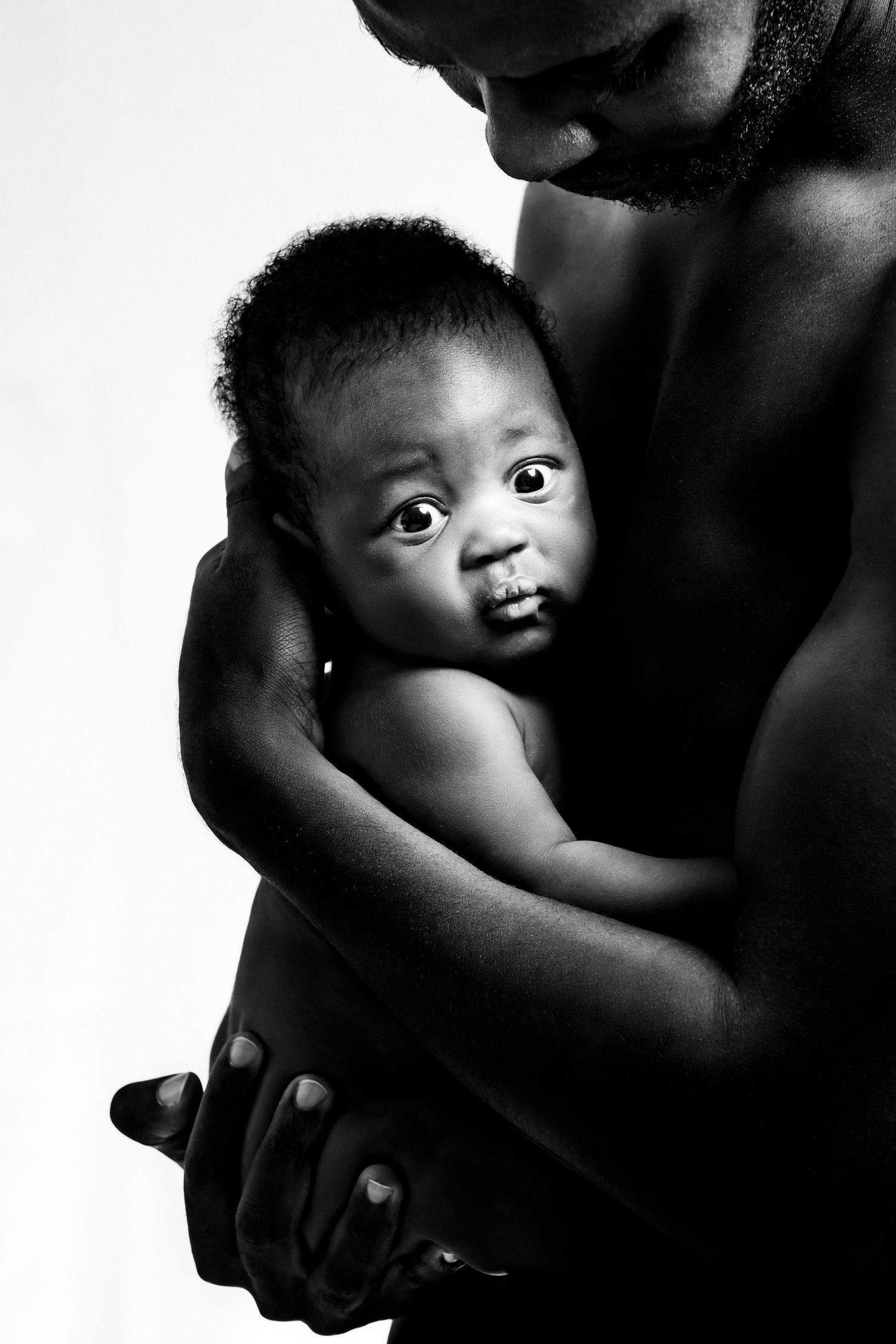 Black and white artistic portraits showing tender moments between parent and child.